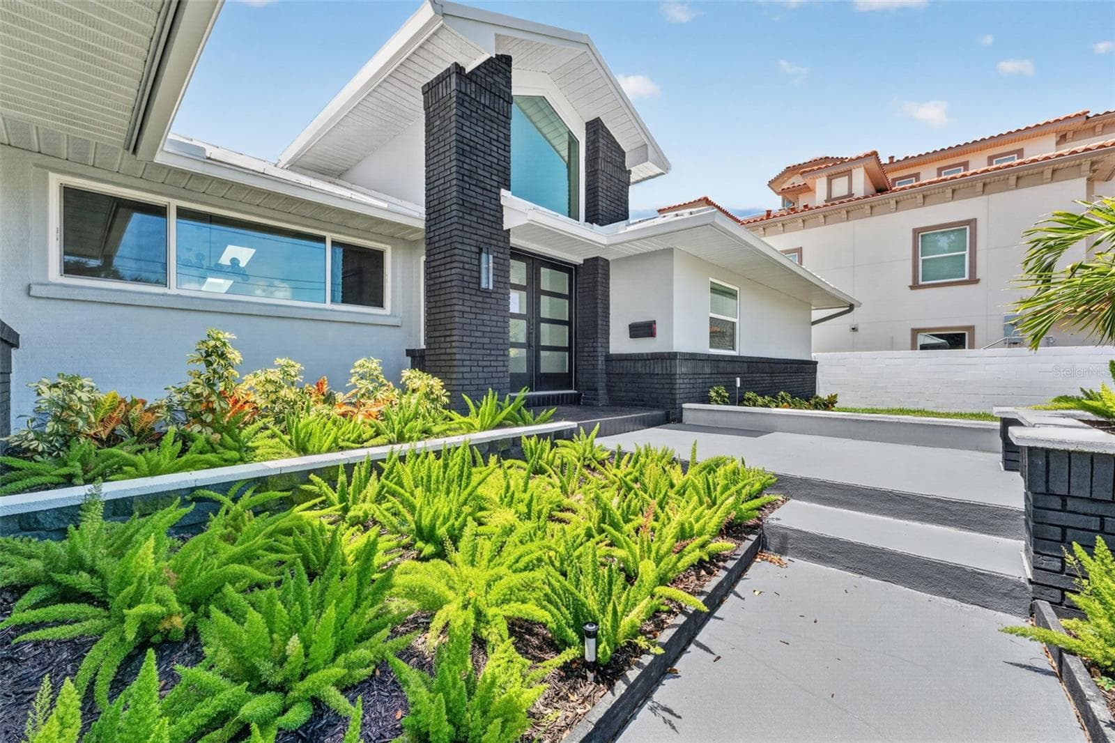 Beautifully landscaped walkway creates a warm and inviting entrance to the home. - 2936 68TH AVE S, ST PETERSBURG