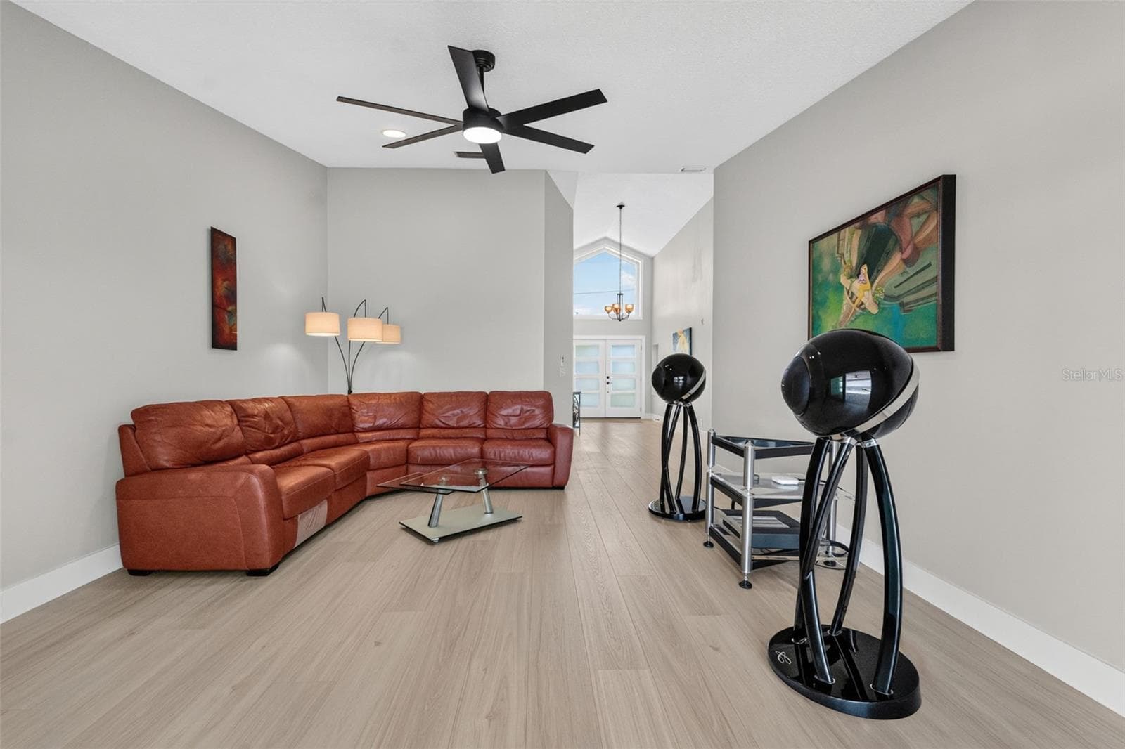 Formal living room with soaring vaulted ceilings and luxury vinyl plank flooring, creating a grand and inviting space. - 2936 68TH AVE S, ST PETERSBURG