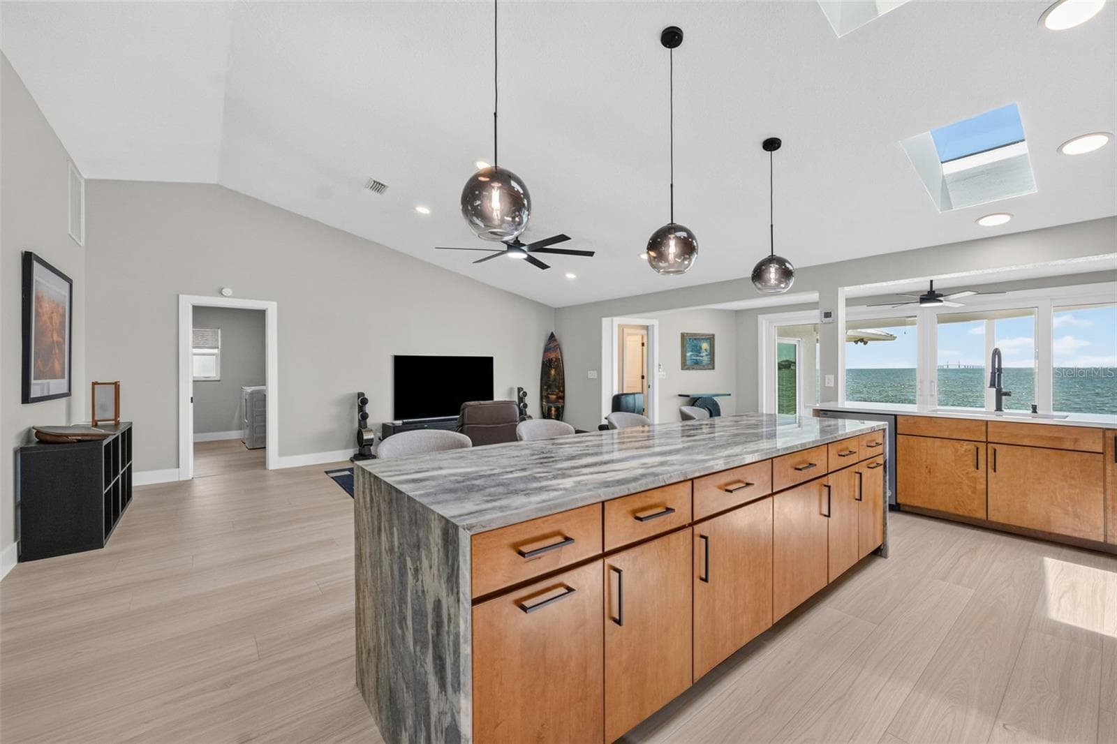 Expansive kitchen island featuring Level 5 granite with a dramatic waterfall edge - 2936 68TH AVE S, ST PETERSBURG