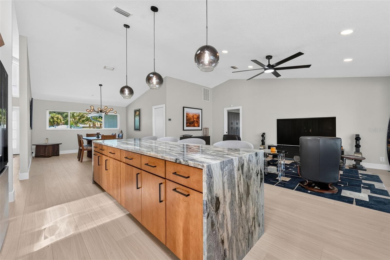 Seamless open-concept design connects the kitchen and family room, creating the perfect space for gatherings and everyday living. - 2936 68TH AVE S, ST PETERSBURG