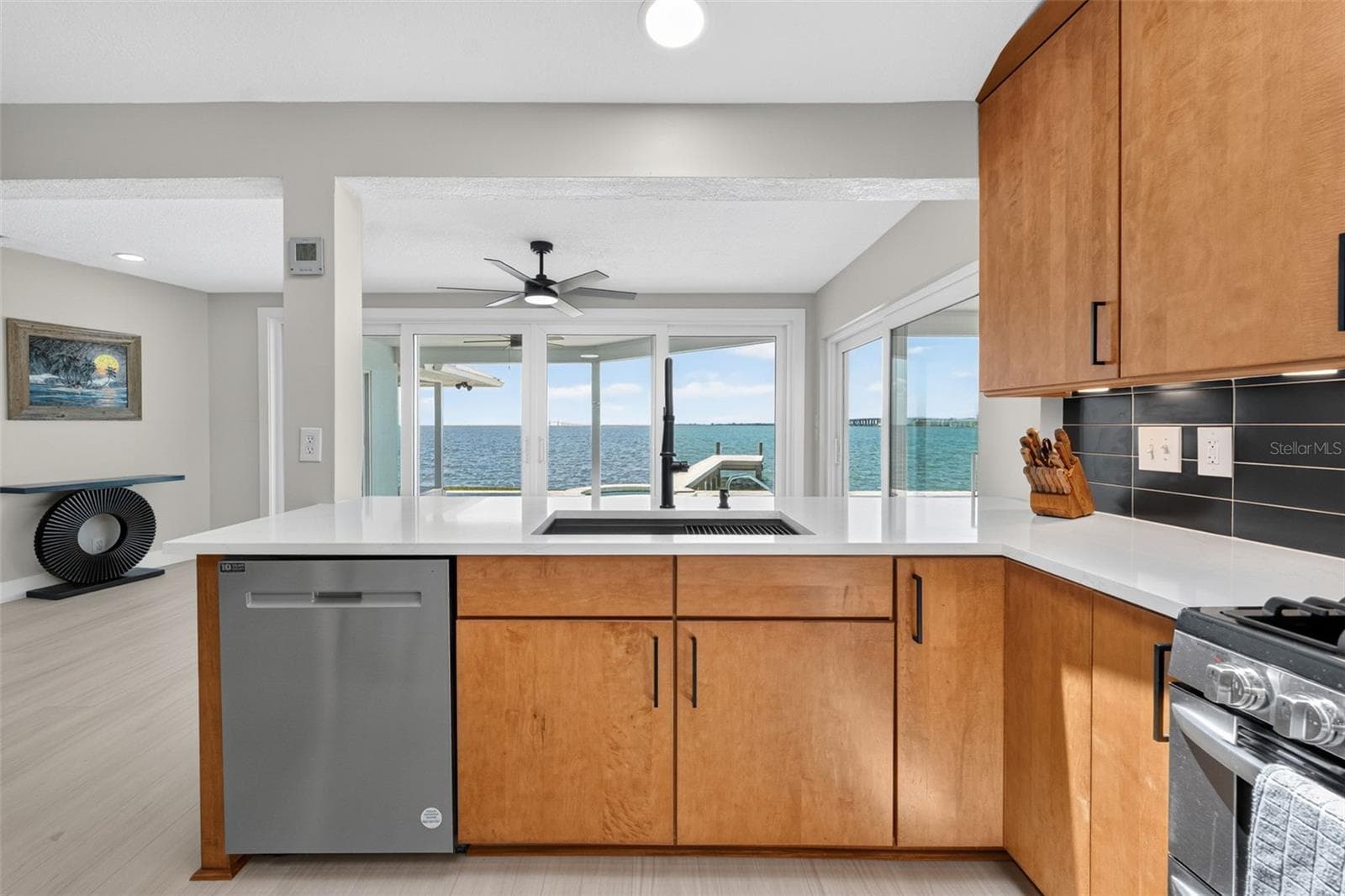 Enjoy abundant natural light and serene water views while cooking or dining in this bright, airy kitchen. - 2936 68TH AVE S, ST PETERSBURG