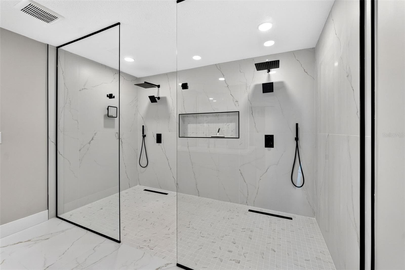 Oversized walk-in shower with seamless glass enclosure creating a spa-like experience - 2936 68TH AVE S, ST PETERSBURG