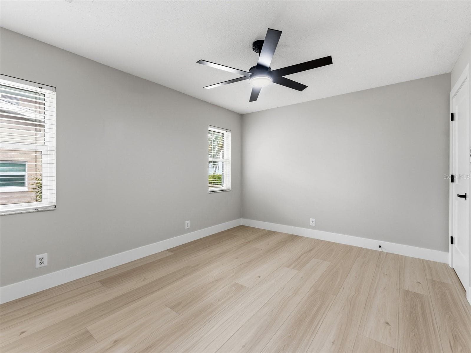 Bedroom 3 with new ceiling fan, fresh paint and baseboards. - 2936 68TH AVE S, ST PETERSBURG