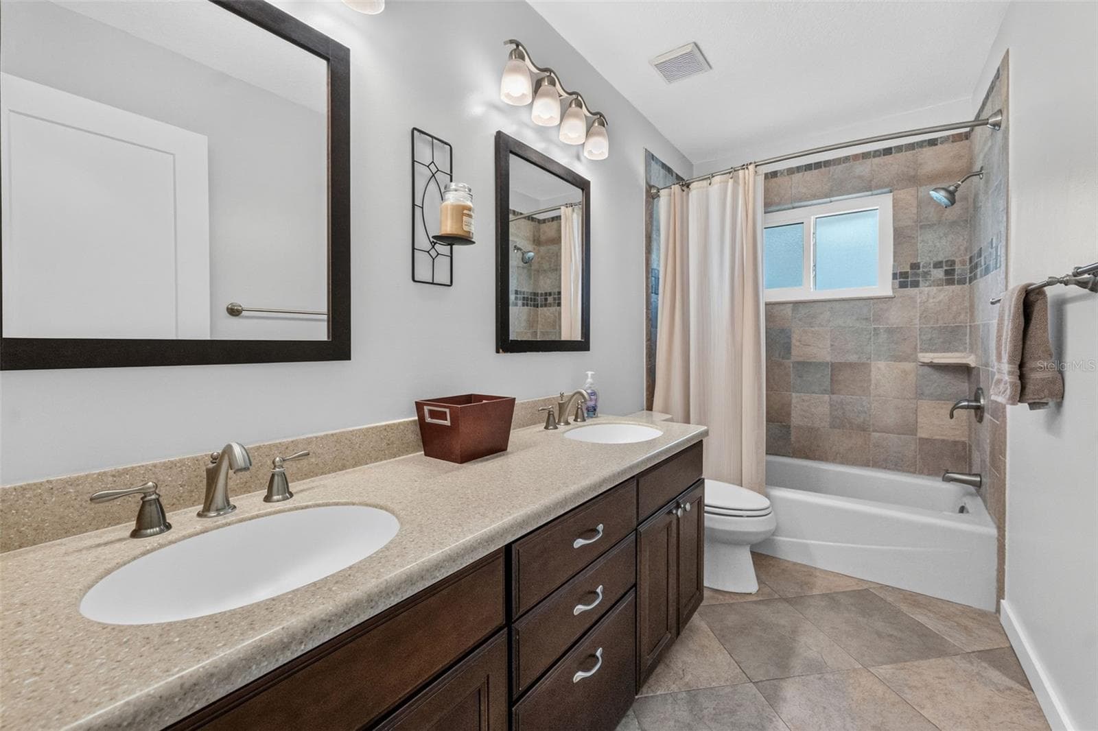 Hall bathroom featuring a large double vanity, perfect for family use and morning routines. - 2936 68TH AVE S, ST PETERSBURG