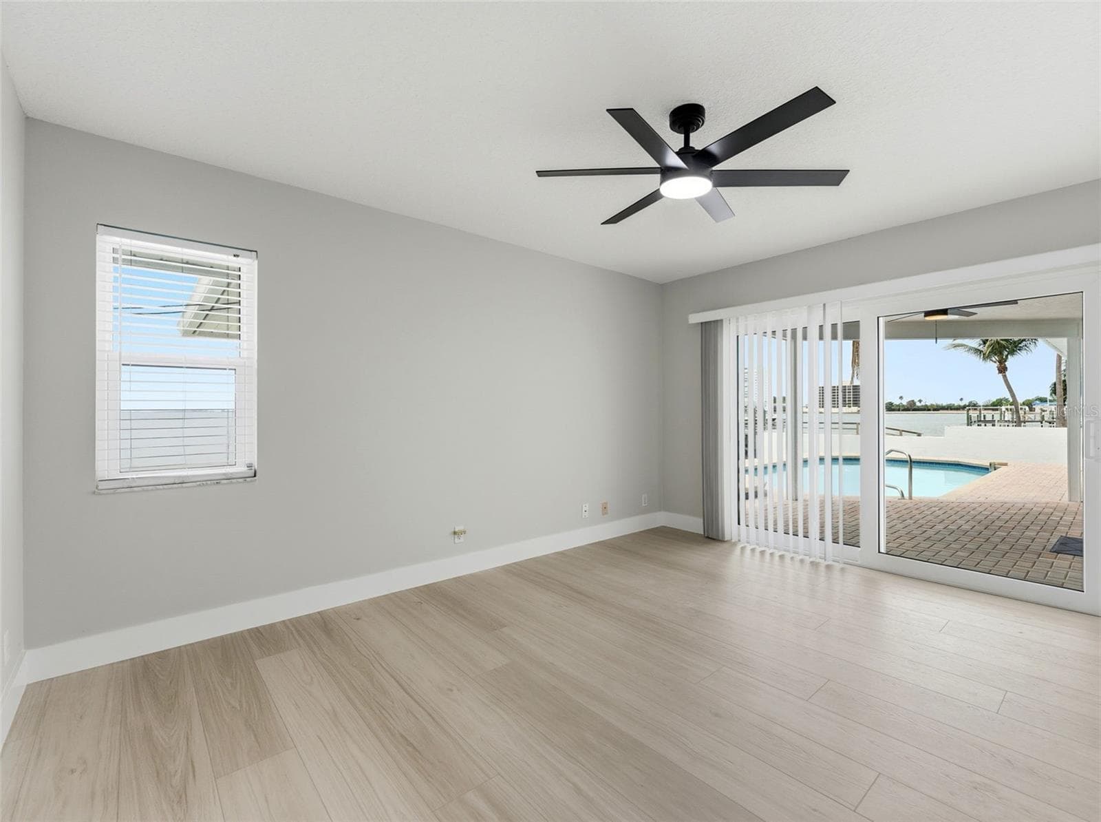Bedroom 4 with sliding glass doors leading to the pool deck - 2936 68TH AVE S, ST PETERSBURG