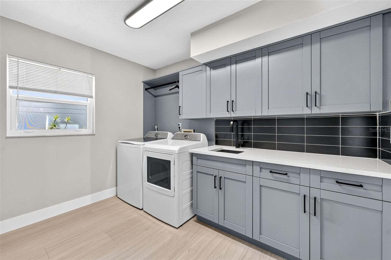 Spacious new laundry suite with utility sink, washer and dryer, and abundant built-in storage - 2936 68TH AVE S, ST PETERSBURG