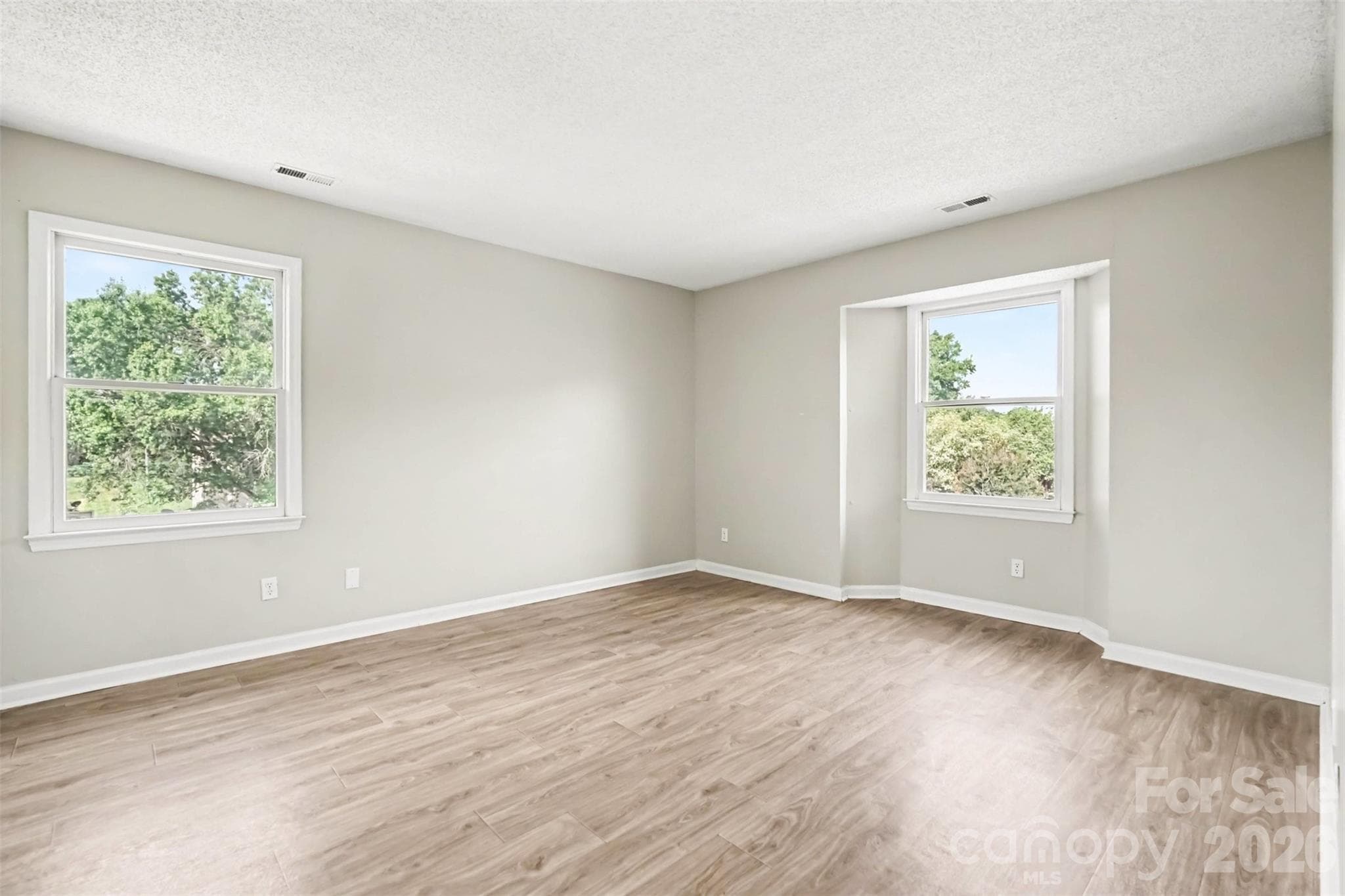 Large primary bedroom with bay window... - 6165 Meadow Rose Lane, Charlotte