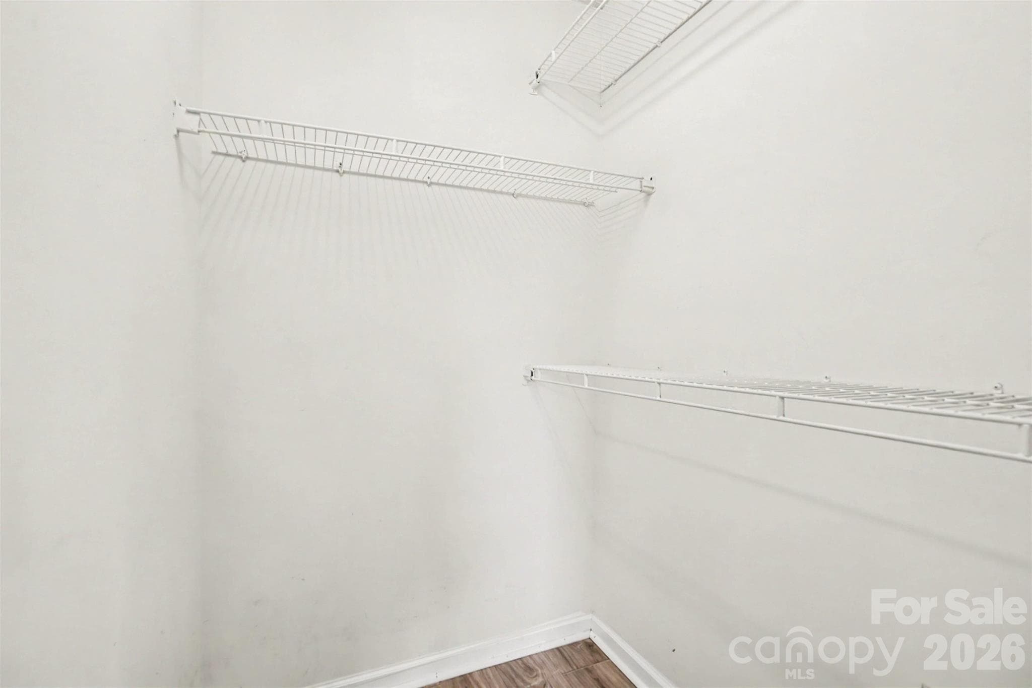 Primary bedroom's large walk-in closet. - 6165 Meadow Rose Lane, Charlotte