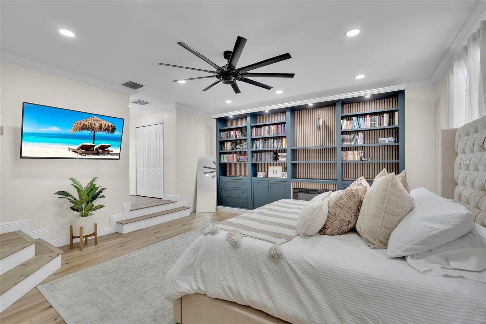 A moody and inviting primary retreat, thoughtfully designed with custom built-ins, an electric fireplace, and a unique step-down layout that adds character and distinction. - 1250 LORETTO CIR, ODESSA