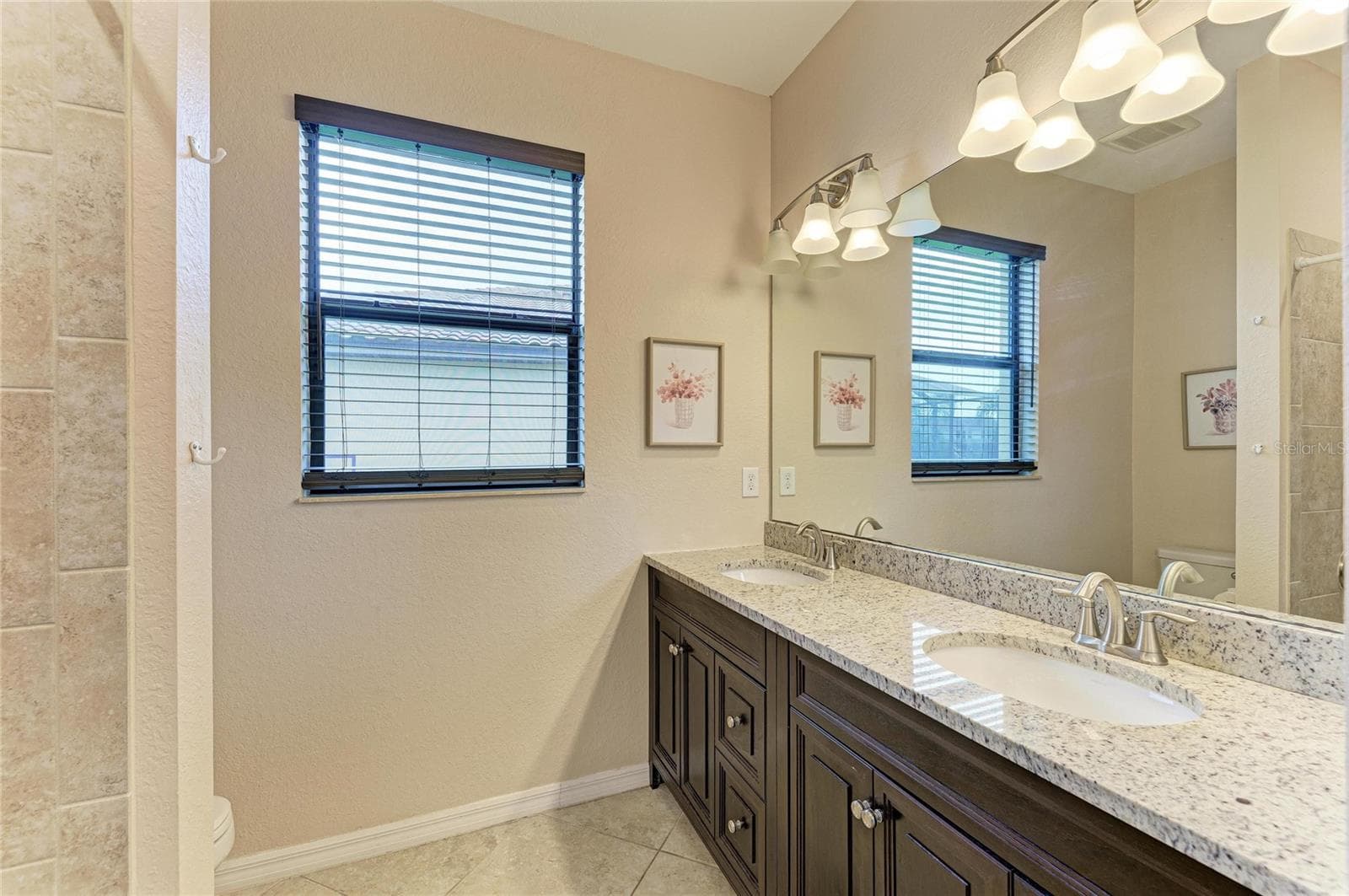 Guest bathroom with dual sinks - 3512 SAVANNA PALMS CT, LAKEWOOD RANCH