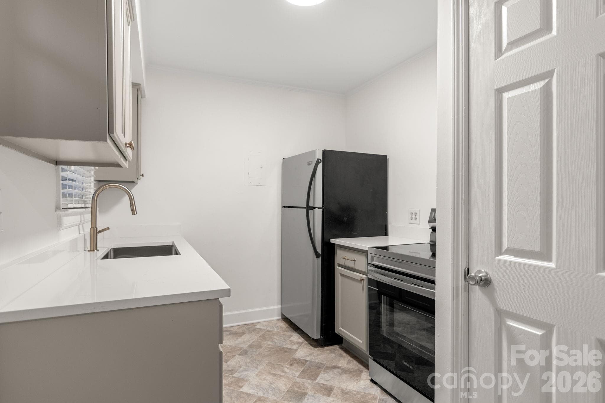 New cabinets and quartz countertops! Kitchen overlooks back yard - 212 Wakefield Drive, Charlotte