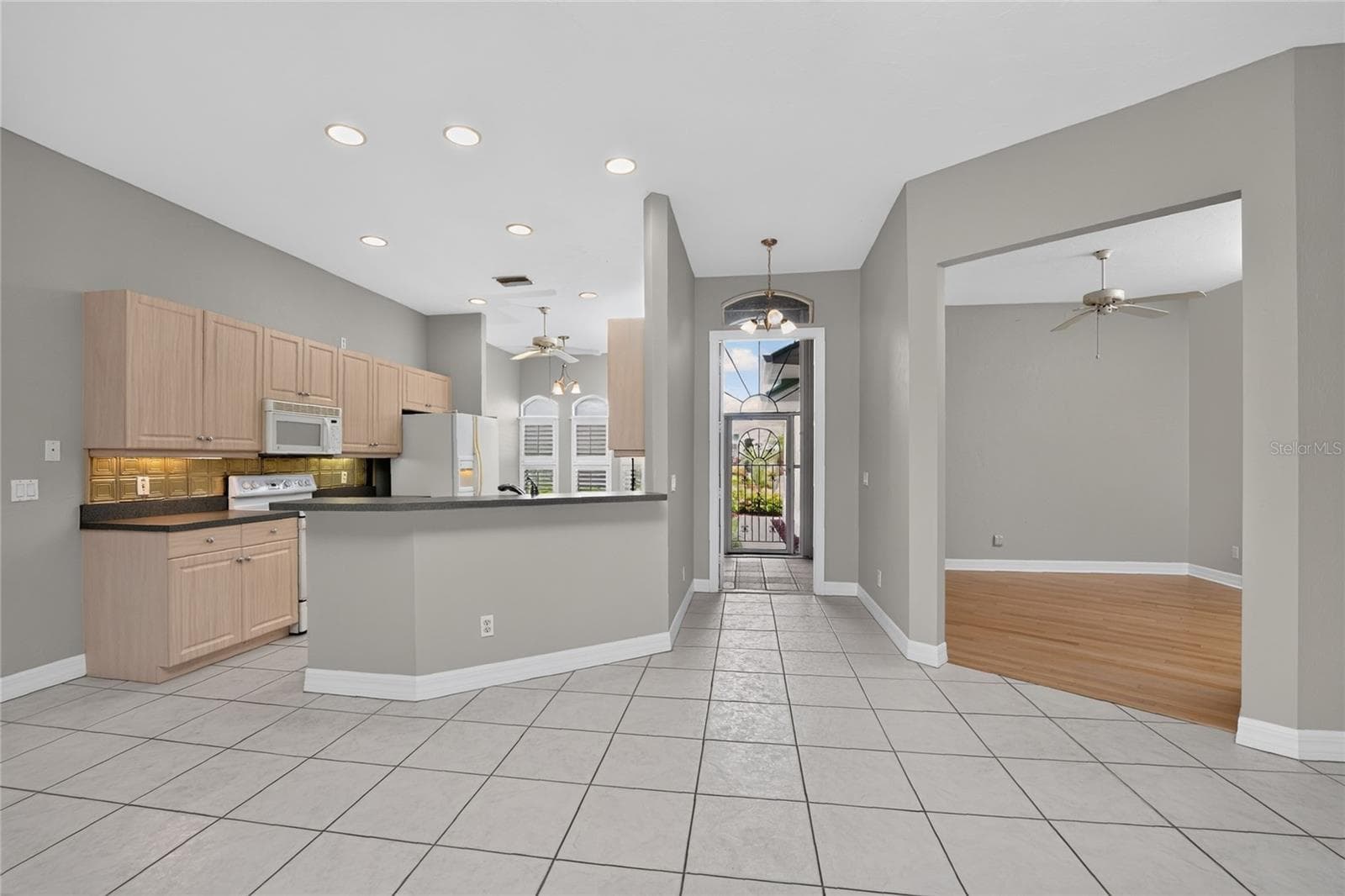 Kitchen, foyer, front entry and den. - 1611 ATARES DRIVE #Unit 111, PUNTA GORDA