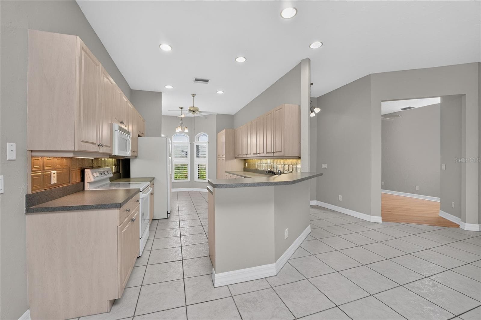 Kitchen, foyer, front entry and den. - 1611 ATARES DRIVE #Unit 111, PUNTA GORDA