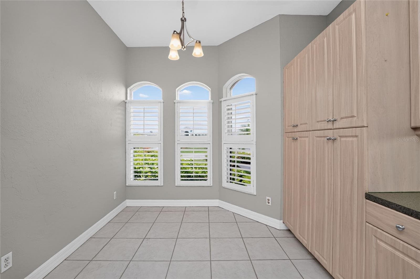 Kitchen dinette with plantation shutters and wall pantry. - 1611 ATARES DRIVE #Unit 111, PUNTA GORDA