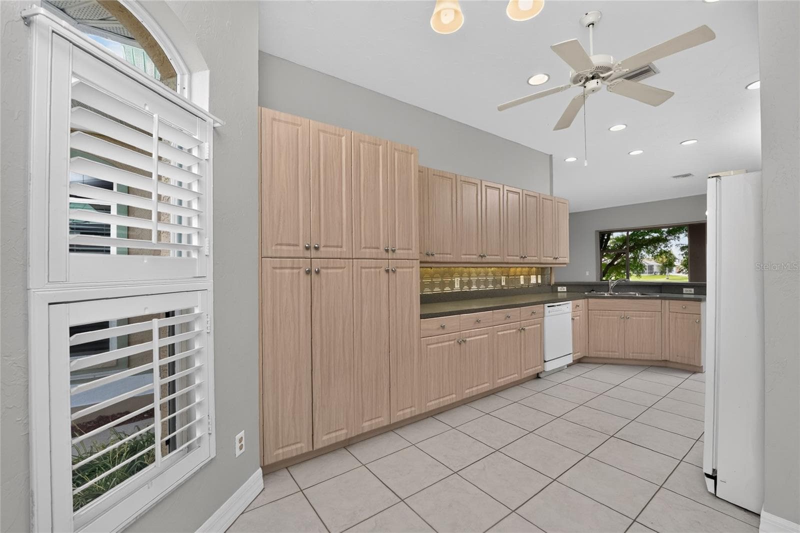 Kitchen dinette with plantation shutters and wall pantry. - 1611 ATARES DRIVE #Unit 111, PUNTA GORDA