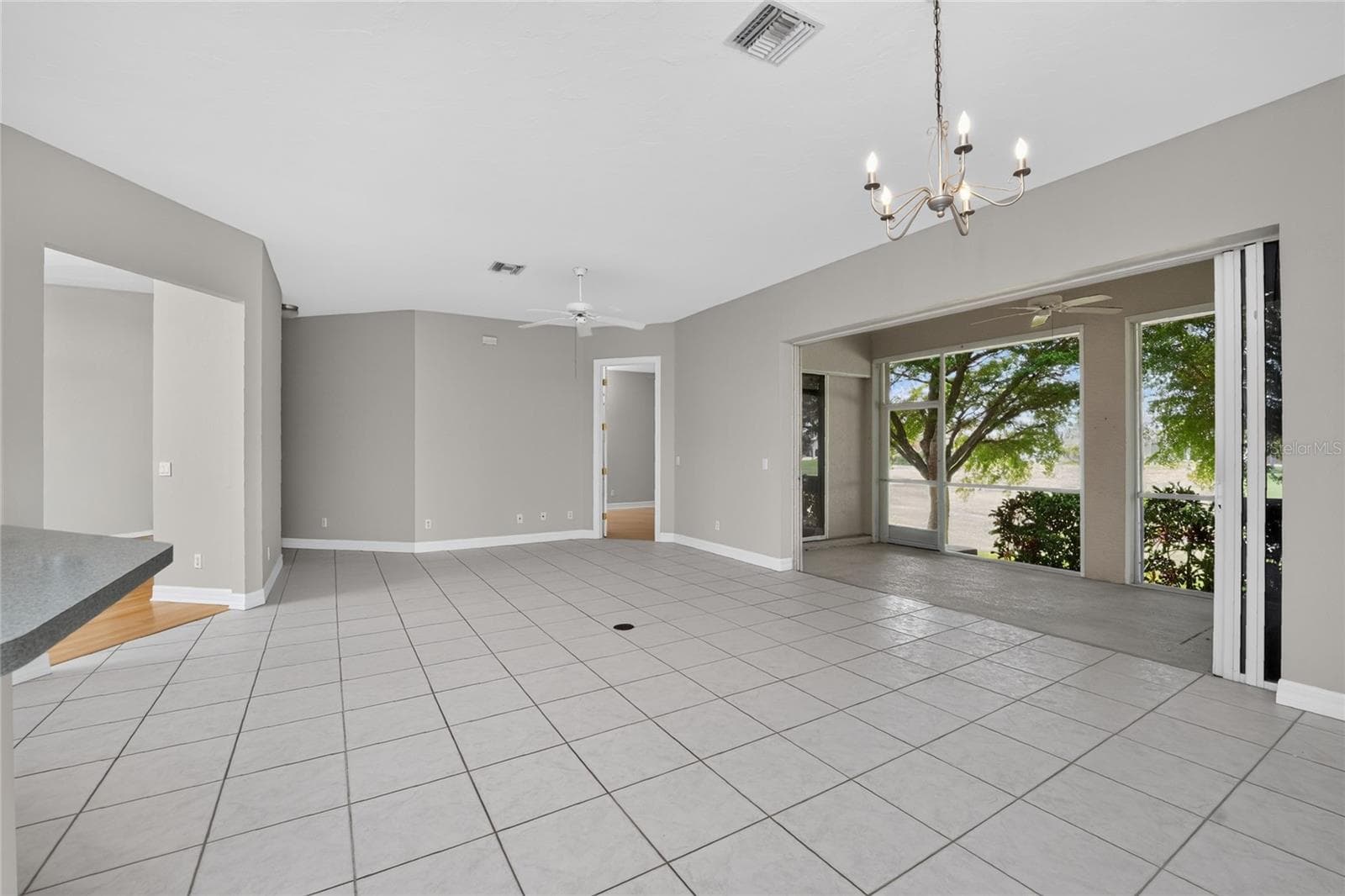Great room with screened lanai and pocketing patio doors. - 1611 ATARES DRIVE #Unit 111, PUNTA GORDA