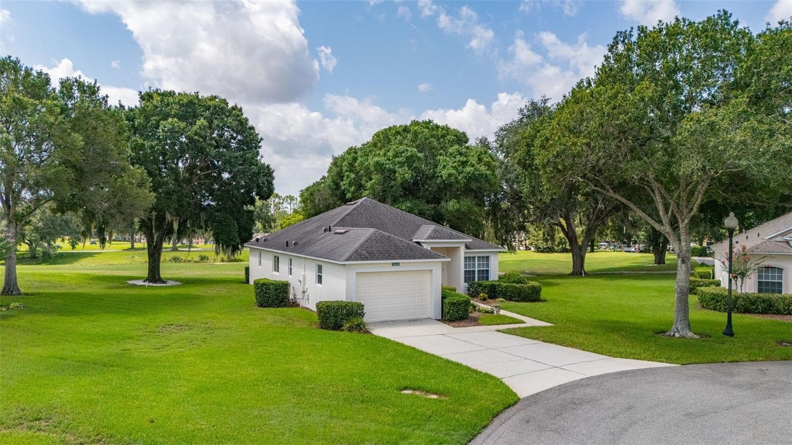 View of 3604 Kingswood Court with 18th hole and Clubhouse in background. - 3604 KINGSWOOD CT, CLERMONT