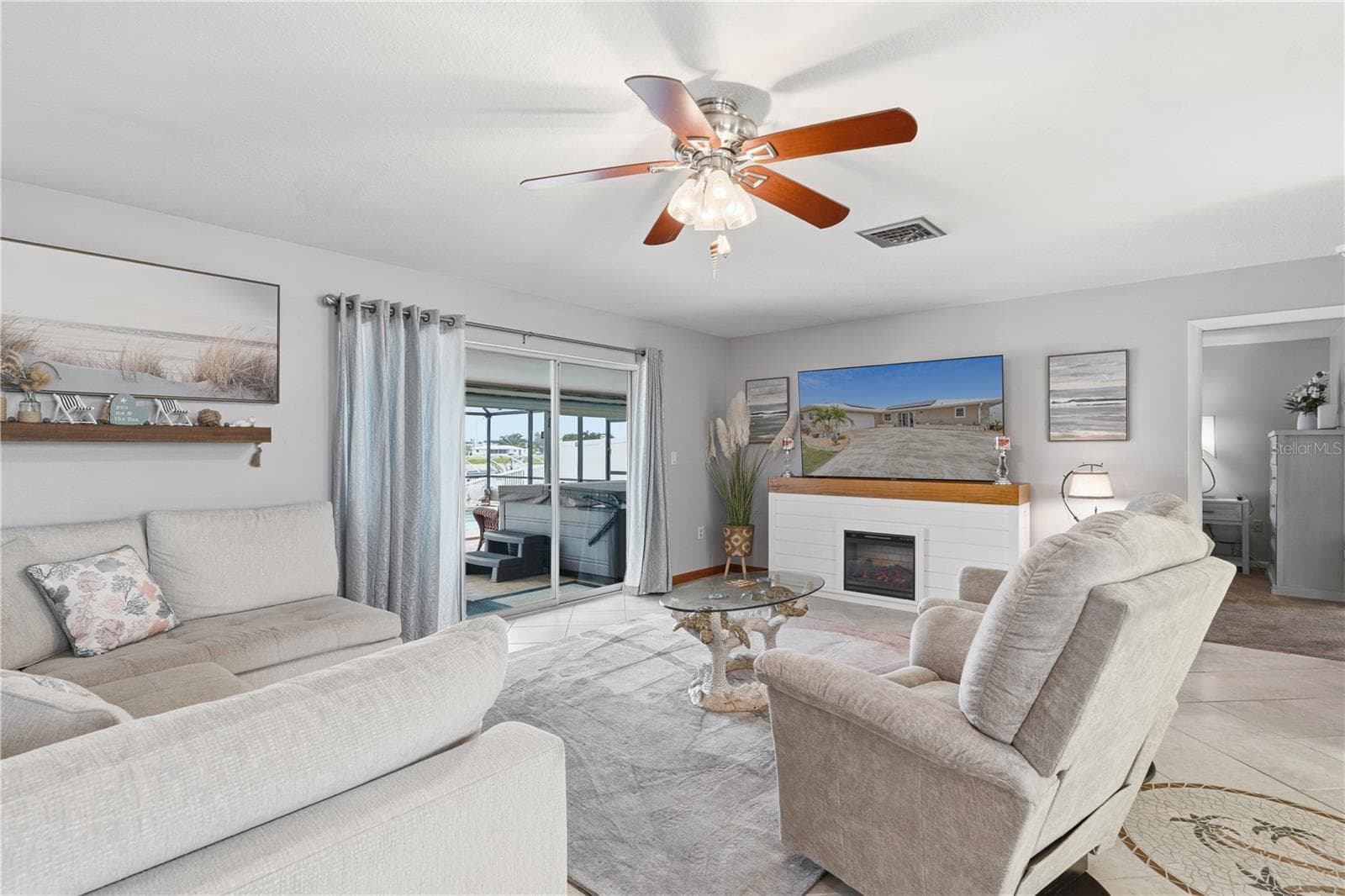 Spacious Living Room with Electric Fireplace and Pool Access - 2284 BROAD RANCH DR, PORT CHARLOTTE