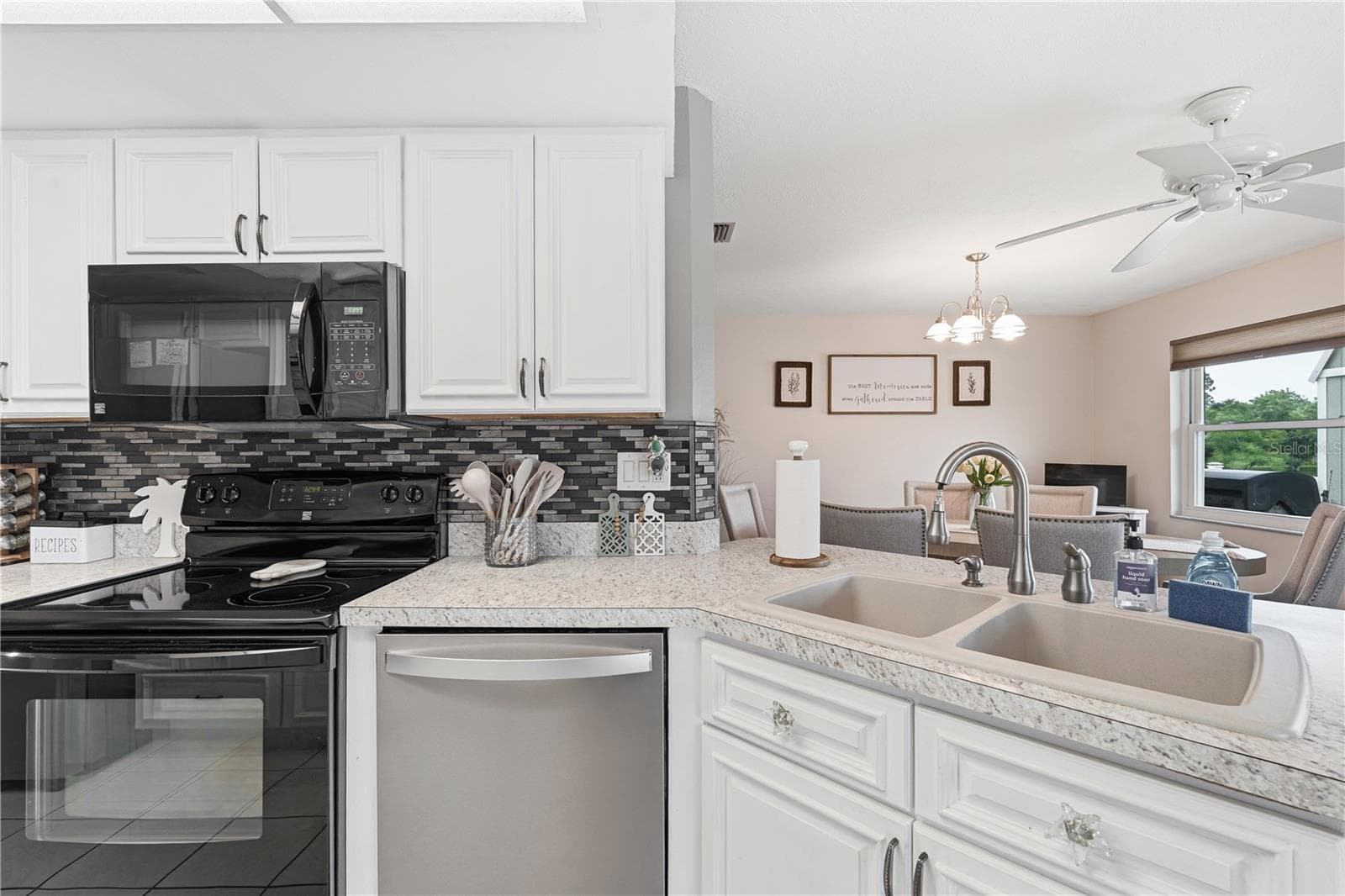 Kitchen with Tiled Backsplash, Breakfast Bar, and Natural Flow - 2284 BROAD RANCH DR, PORT CHARLOTTE