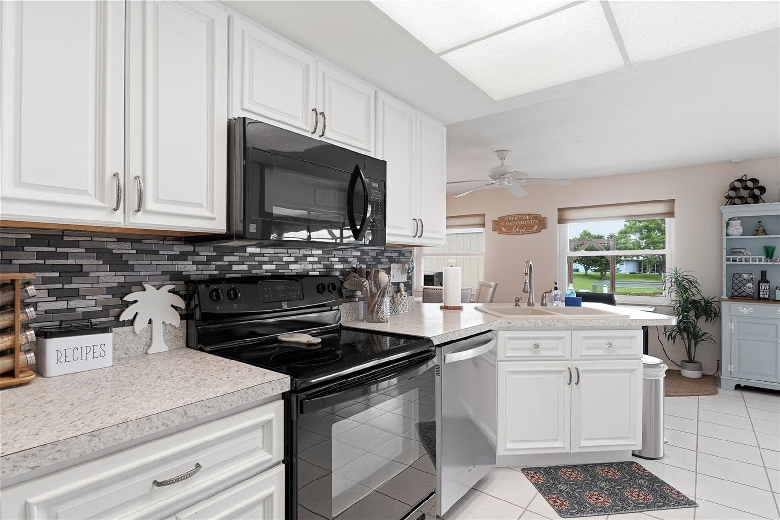 Well Appointed Kitchen with Raised Panel Cabinetry and Tile Backsplash - 2284 BROAD RANCH DR, PORT CHARLOTTE