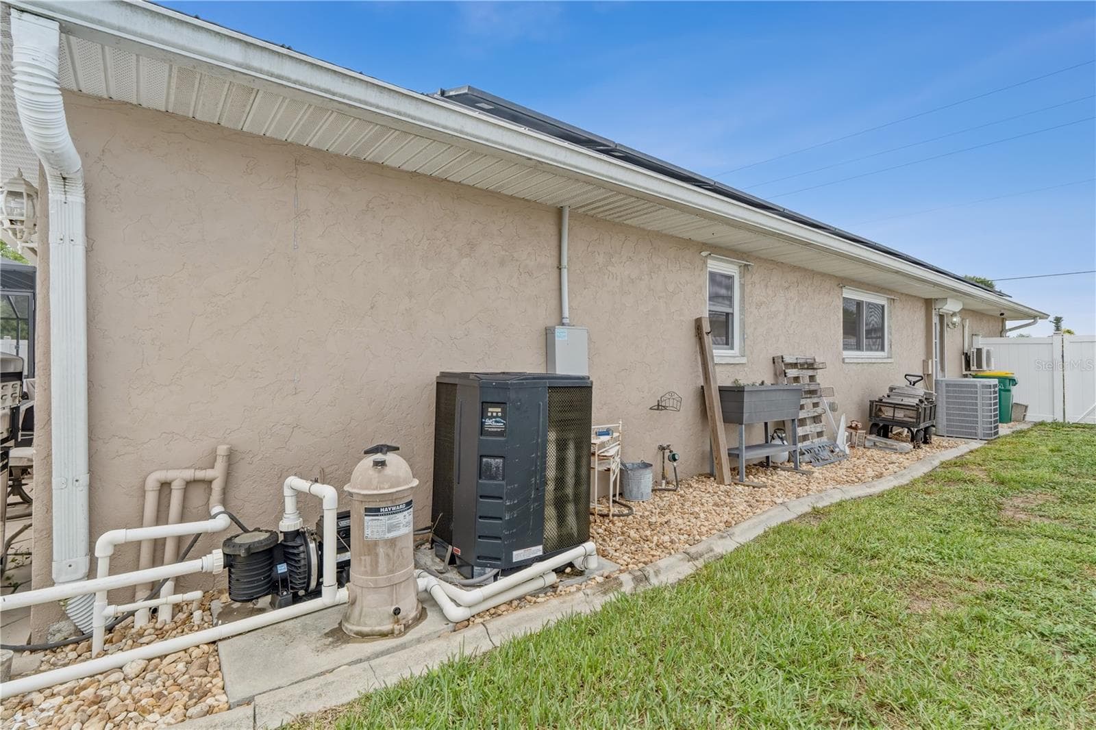 Side Exterior Showcasing Pool Equipment and Utility Access - 2284 BROAD RANCH DR, PORT CHARLOTTE