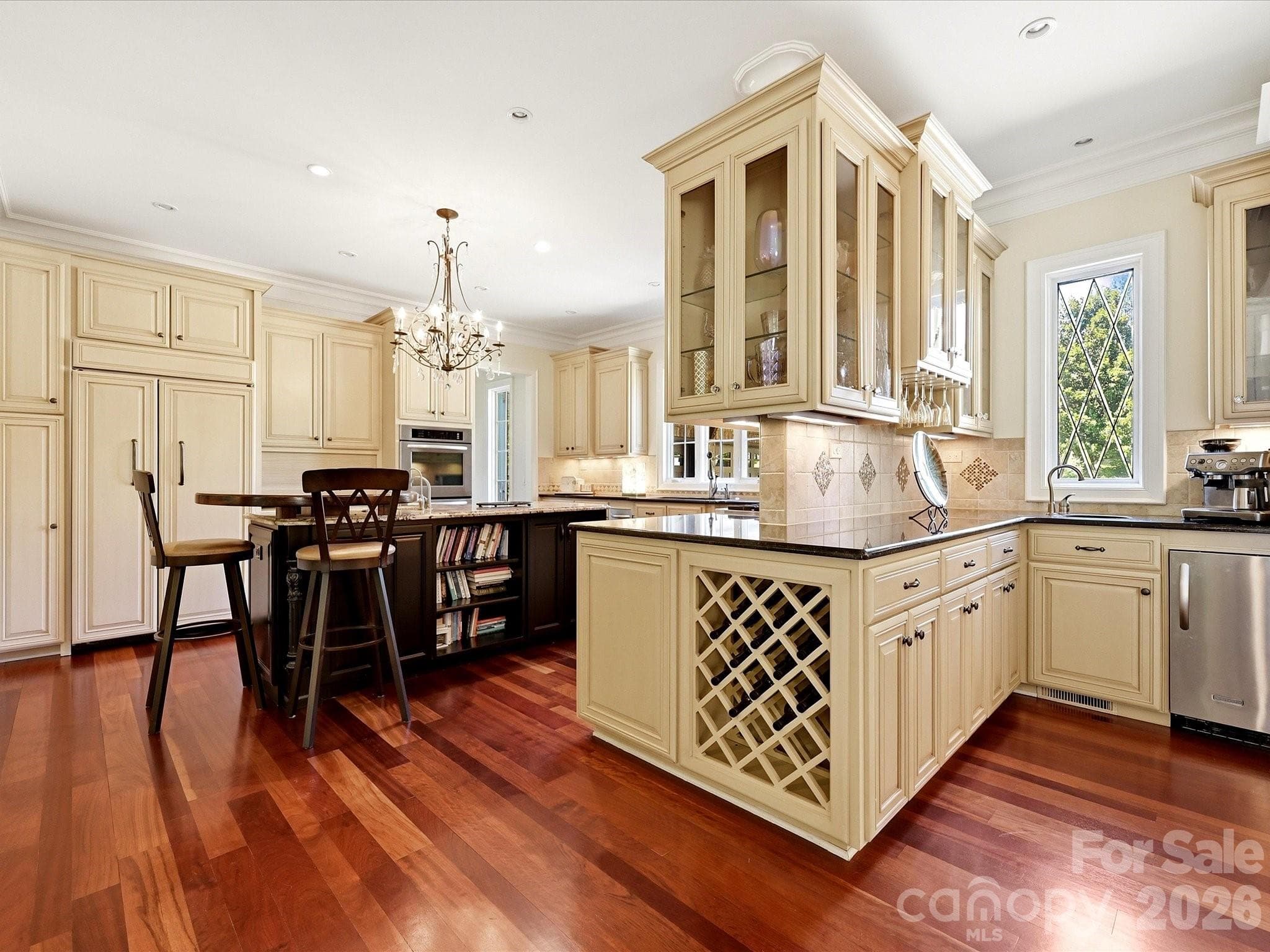 Kitchen with glass front cabinets flanking the wet bar - 2320 Brawinal Court, Monroe