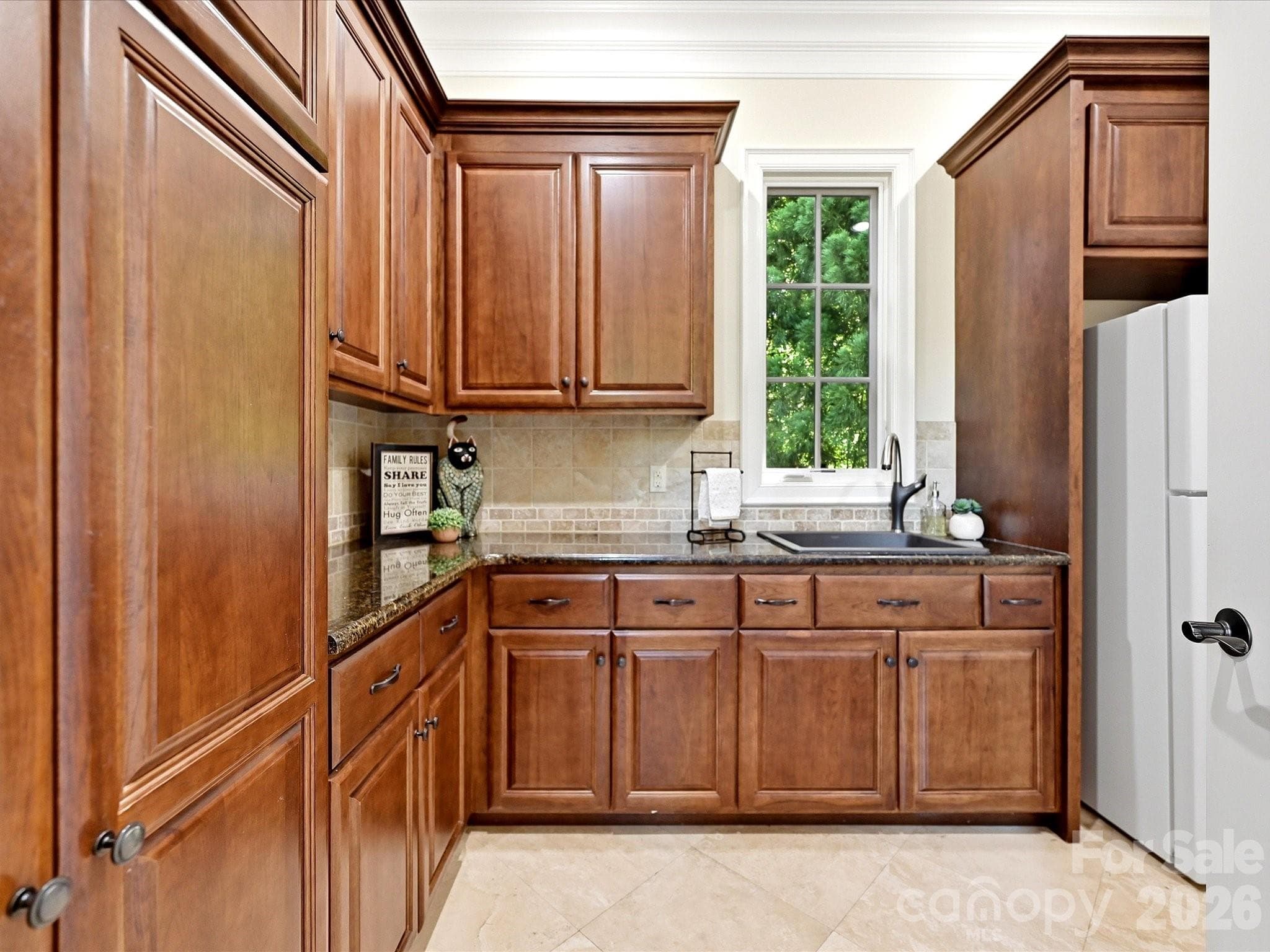Large Laundry Room/Messy Kitchen Area offers tons of counter & cabinet storage - 2320 Brawinal Court, Monroe