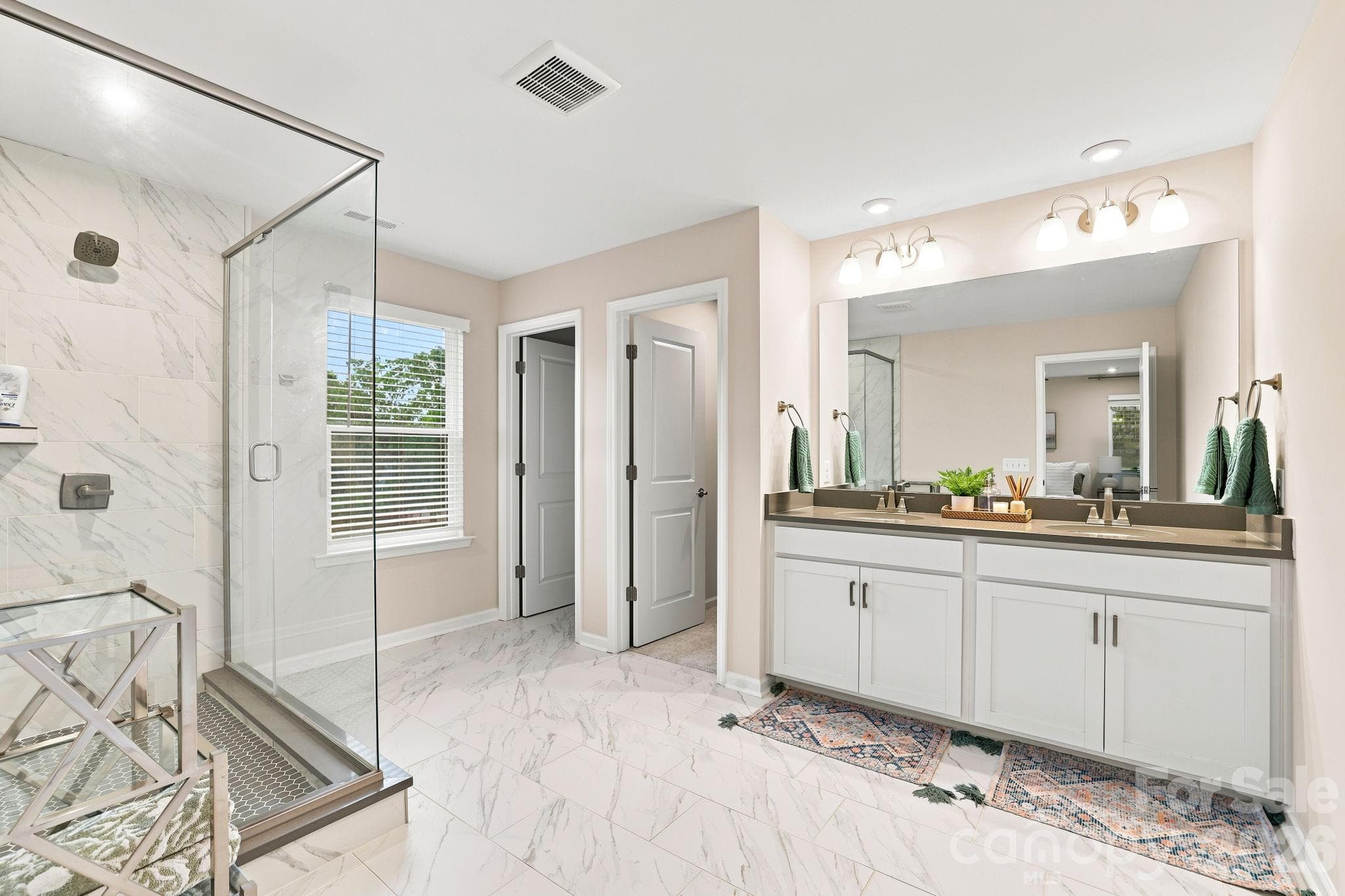 Primary Bath has dual sinks and large tile shower with glass surround. Plenty of space to get ready! - 8226 Franklin Trail Street, Mint Hill