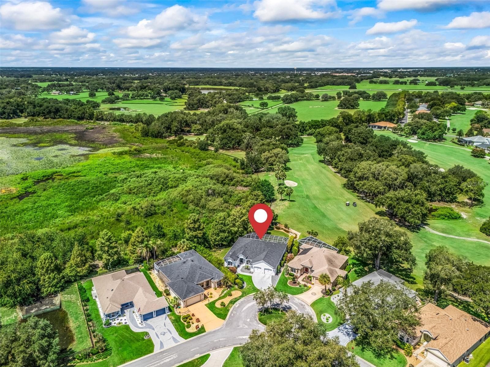 Premier Home w/ Beautiful Surroundings!Aerial perspective highlights the home's desirable location surrounded by lush green space with TIERRA DEL SOL CHAMPIONSHIP GOLF COURSE VIEWS & privacy along the HUDSON MORSE PARR WILDLIFE PRESERVE! - 714 CIMARRON AVE, THE VILLAGES