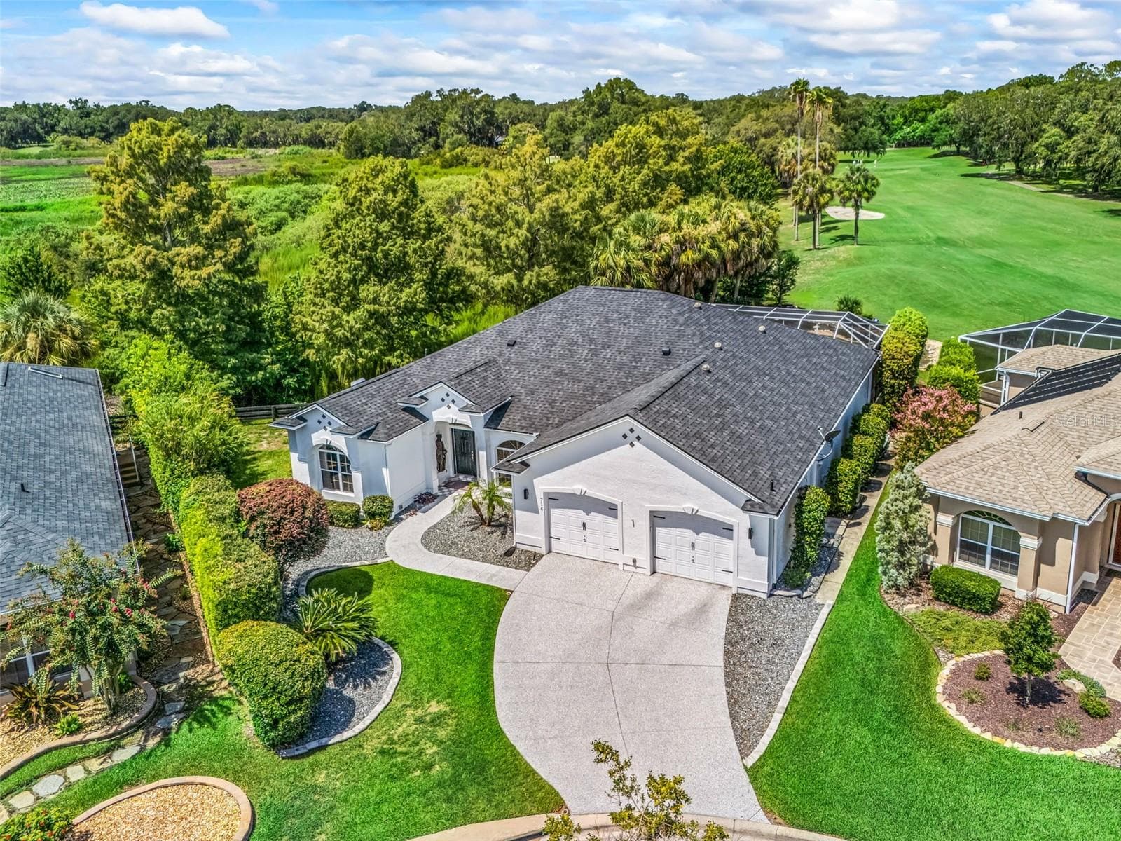 Aerial perspective captures the home's generous footprint, established landscaping, spacious homesite, and picturesque green surroundings. - 714 CIMARRON AVE, THE VILLAGES