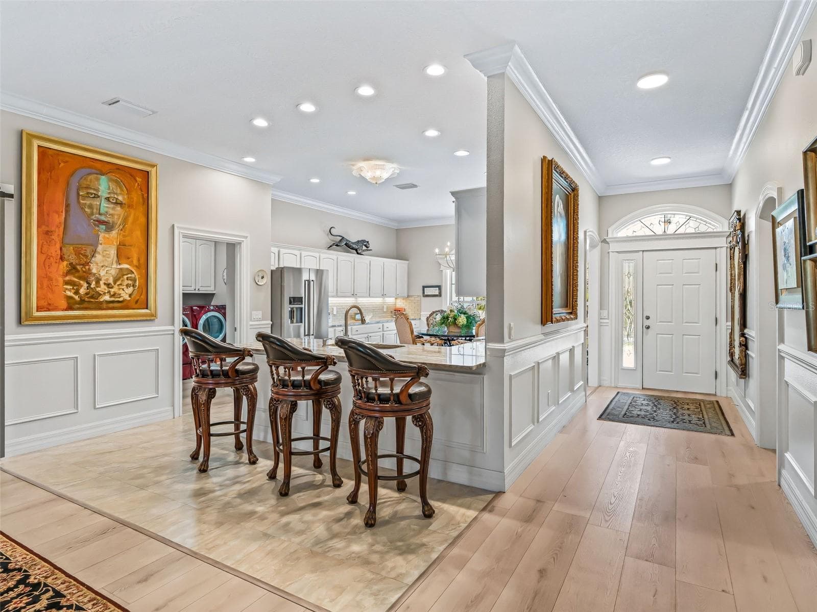 The spacious Rancho Mirage Premier floor plan offers an open flow between the kitchen, dining, and living areas, enhanced by recessed lighting, crown molding, and abundant natural light. - 714 CIMARRON AVE, THE VILLAGES
