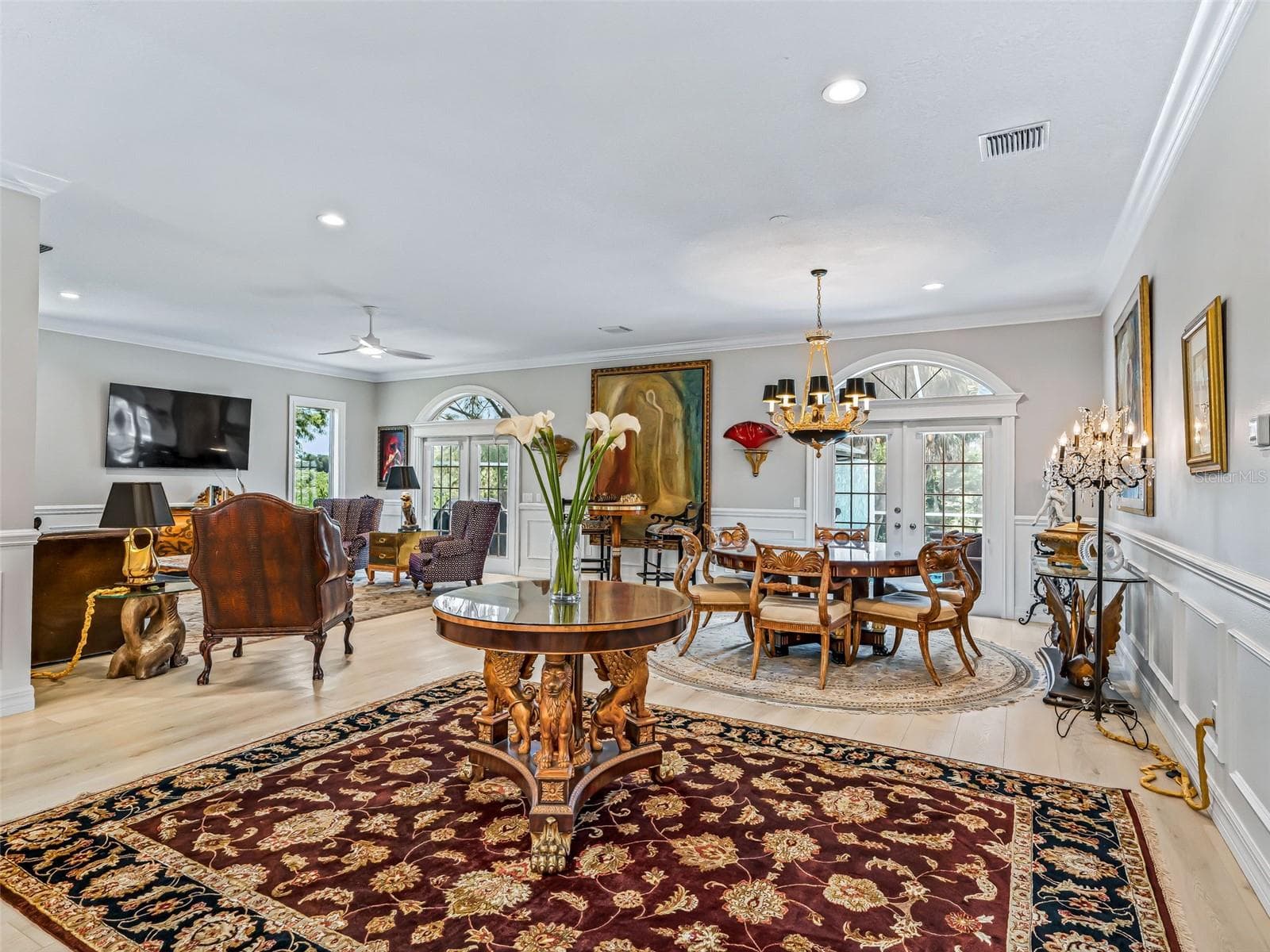 Wide-open Premier floor plan creates an impressive sense of space, with luxury vinyl plank flooring, crown molding, wainscoting, and abundant natural light throughout. - 714 CIMARRON AVE, THE VILLAGES