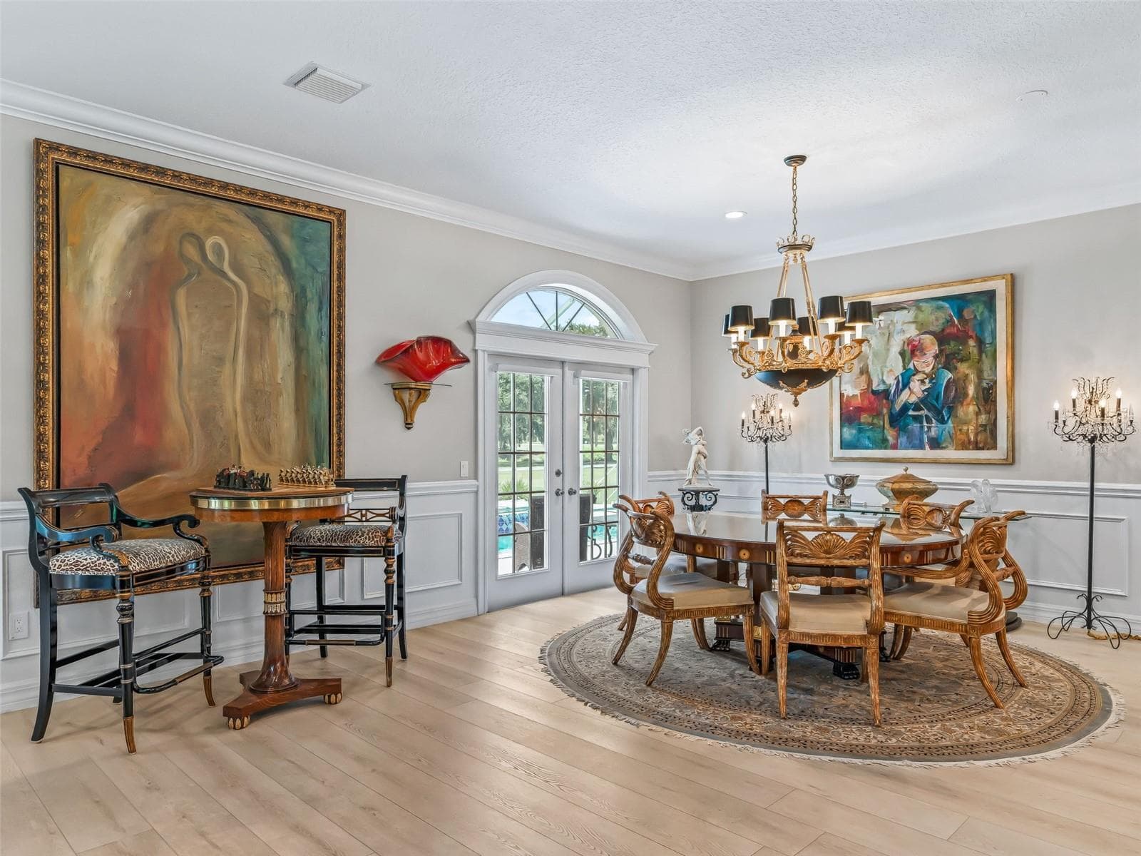 Generously sized dining space offers plenty of room for entertaining and is surrounded by custom trim, decorative moldings, and abundant natural light. - 714 CIMARRON AVE, THE VILLAGES