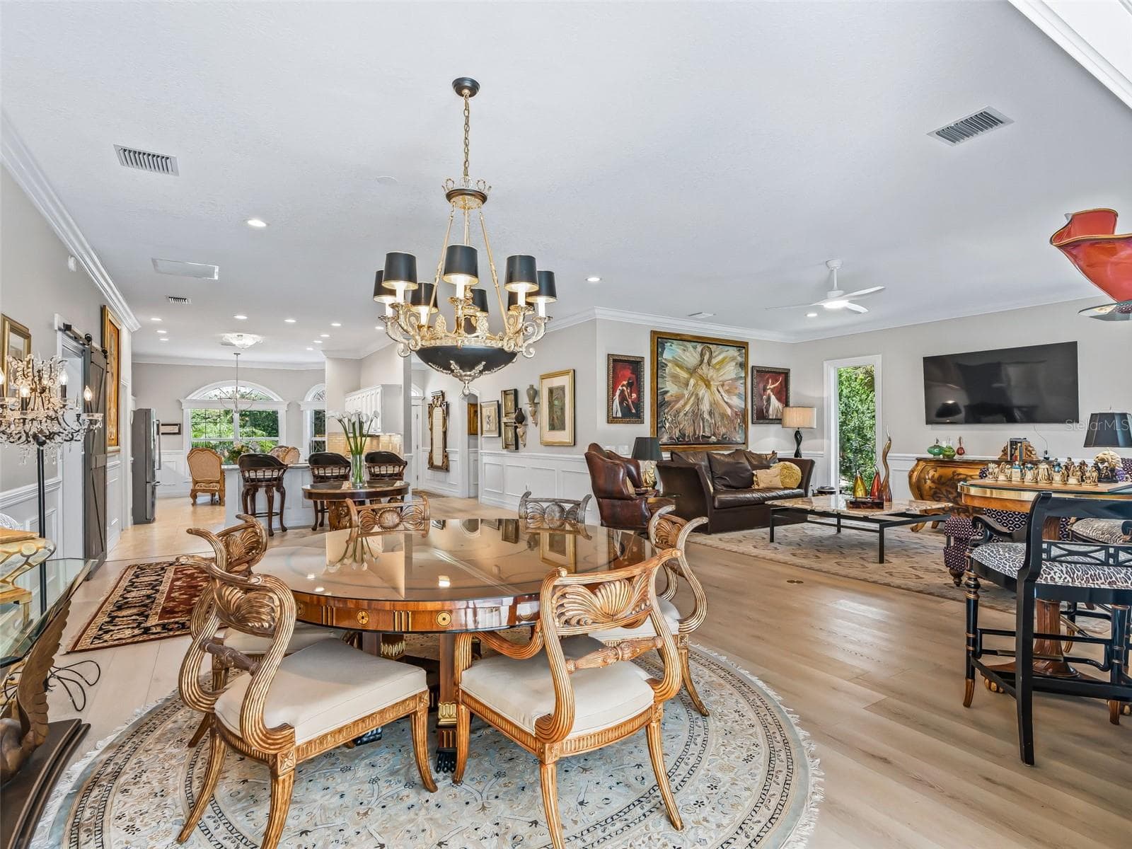 This wide-angle view showcases the home's impressive open layout, allowing the dining, living, and kitchen areas to flow together beautifully. - 714 CIMARRON AVE, THE VILLAGES
