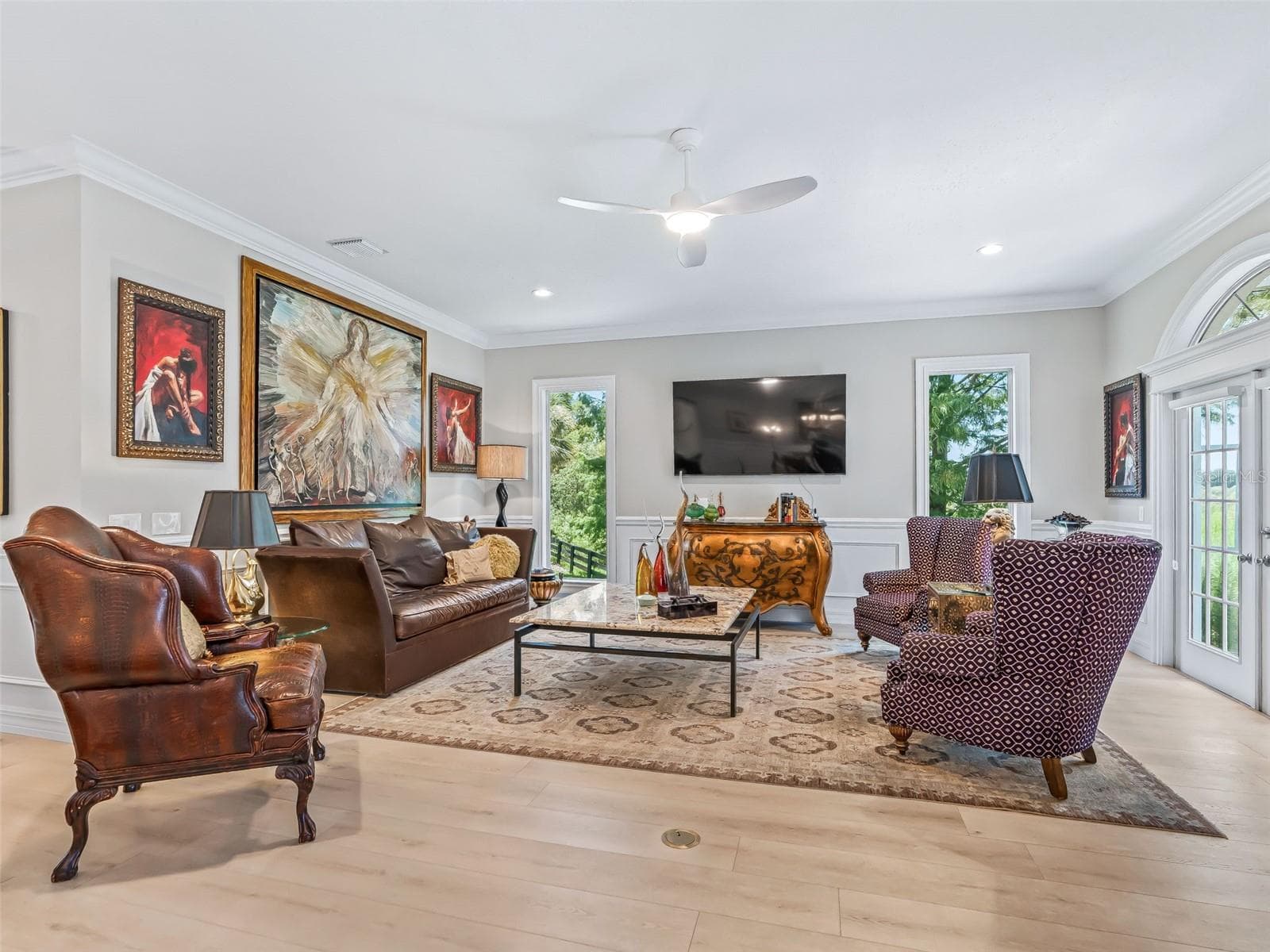 Generously sized living room provides an inviting place to relax or entertain, with large windows, French doors, and abundant natural light. - 714 CIMARRON AVE, THE VILLAGES