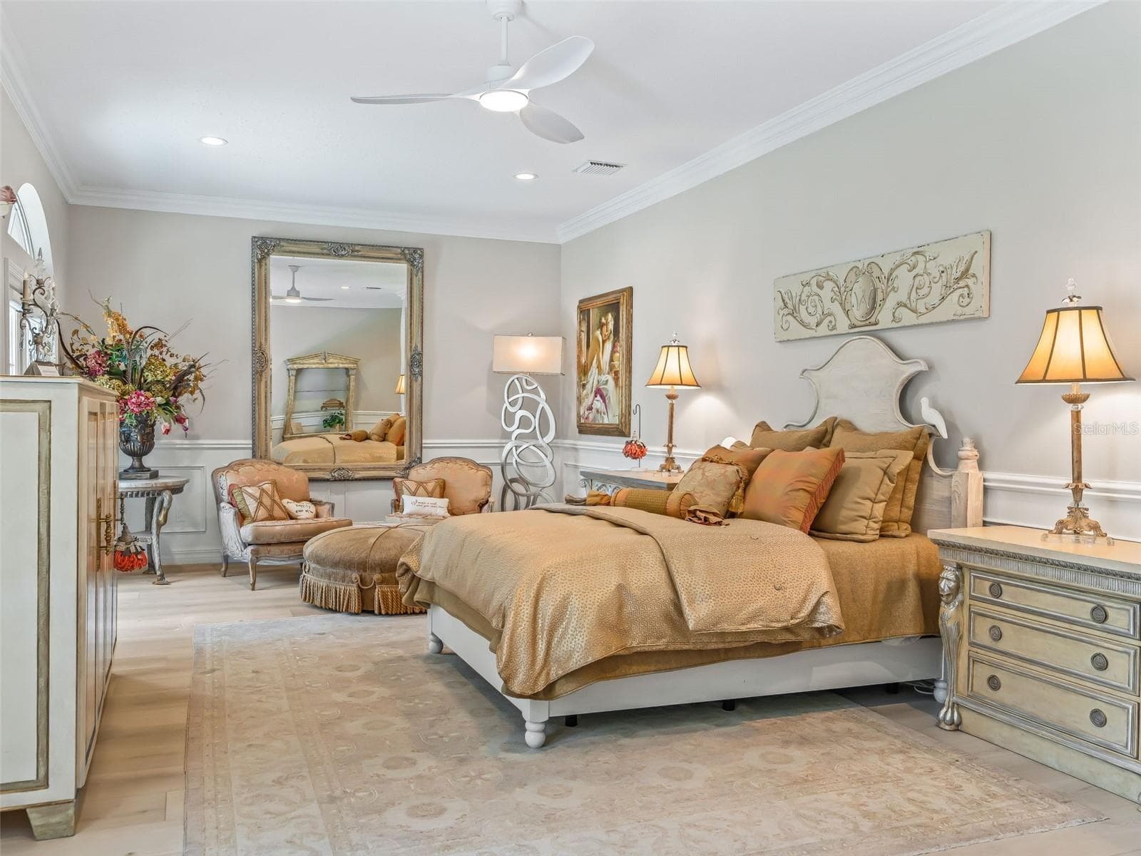 This generously sized primary suite (only portion pictured) offers plenty of room for a substantial bedroom set & sitting areas, enhanced by crown molding, recessed lighting, and soft neutral finishes. - 714 CIMARRON AVE, THE VILLAGES