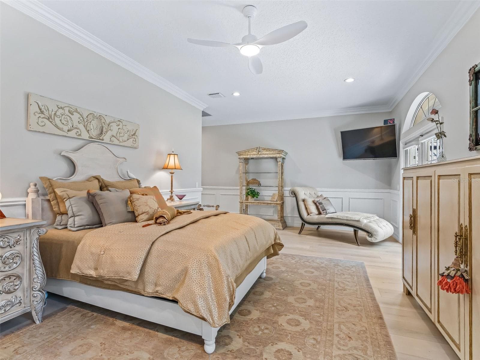 Another view of the primary bedroom showcases its impressive size, luxury vinyl plank flooring, upgraded ceiling fan, and comfortable sitting area. - 714 CIMARRON AVE, THE VILLAGES