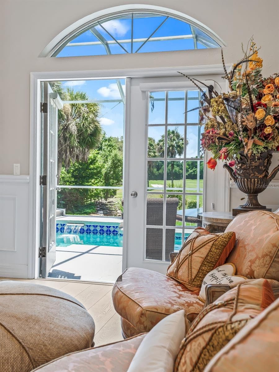 Relaxing views of the sparkling pool are framed by the suite's French doors, creating a wonderful indoor-outdoor connection and private resort-like atmosphere. - 714 CIMARRON AVE, THE VILLAGES