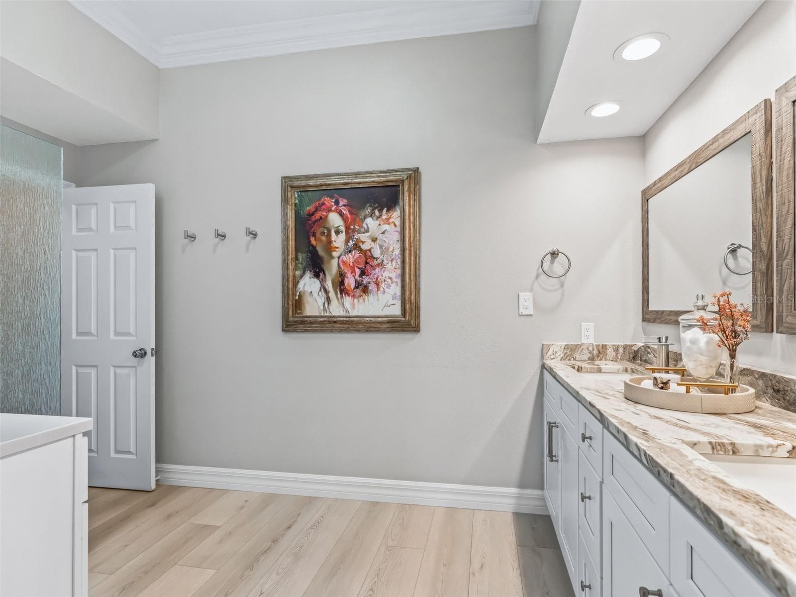 The luxurious primary bath offers a generous layout with a granite-topped vanity, extensive cabinetry, recessed lighting, and elegant neutral finishes. - 714 CIMARRON AVE, THE VILLAGES