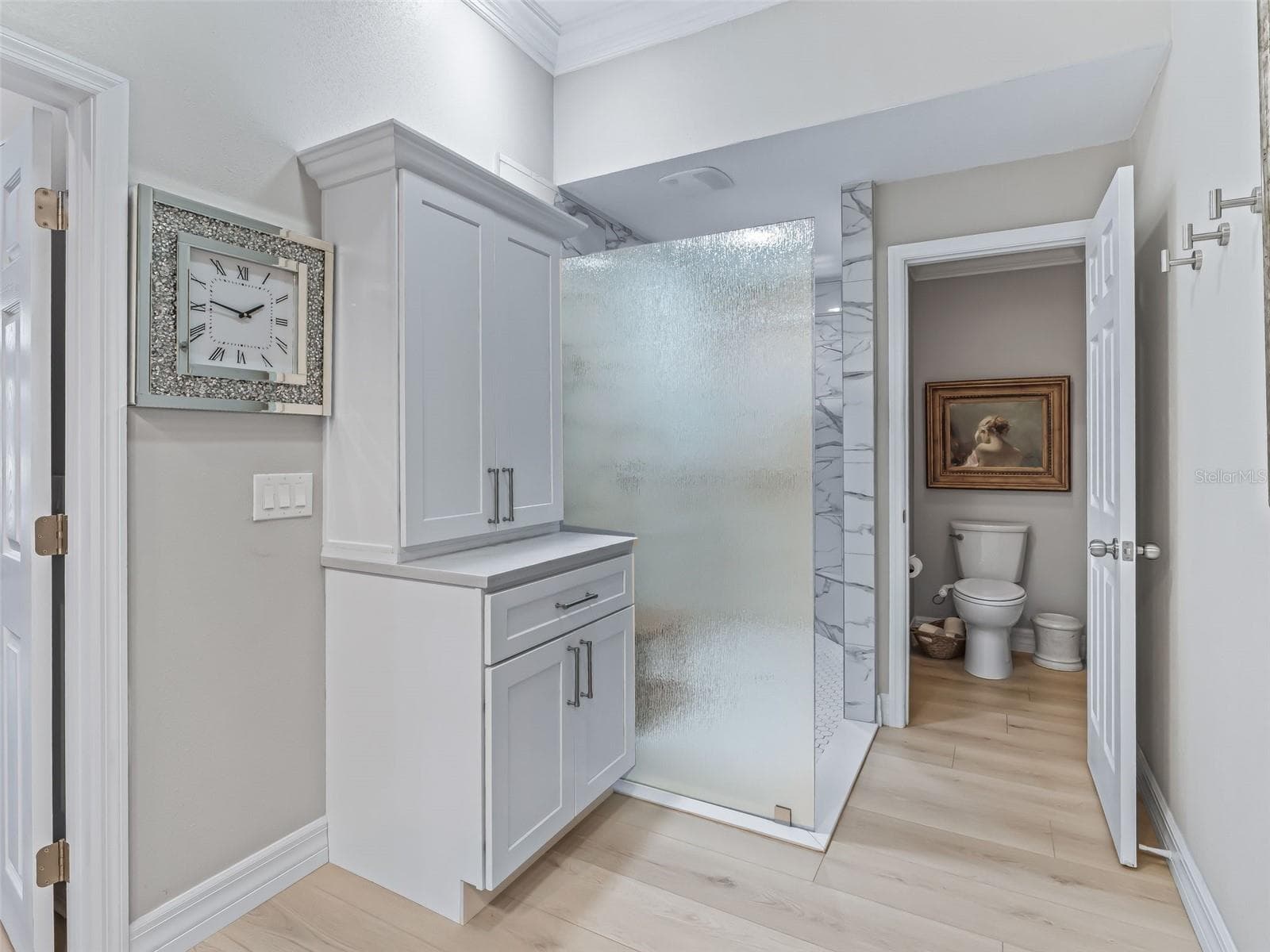 Designed with functionality in mind, the primary bathroom includes additional built-in cabinetry and storage while maintaining a clean, upscale look. - 714 CIMARRON AVE, THE VILLAGES