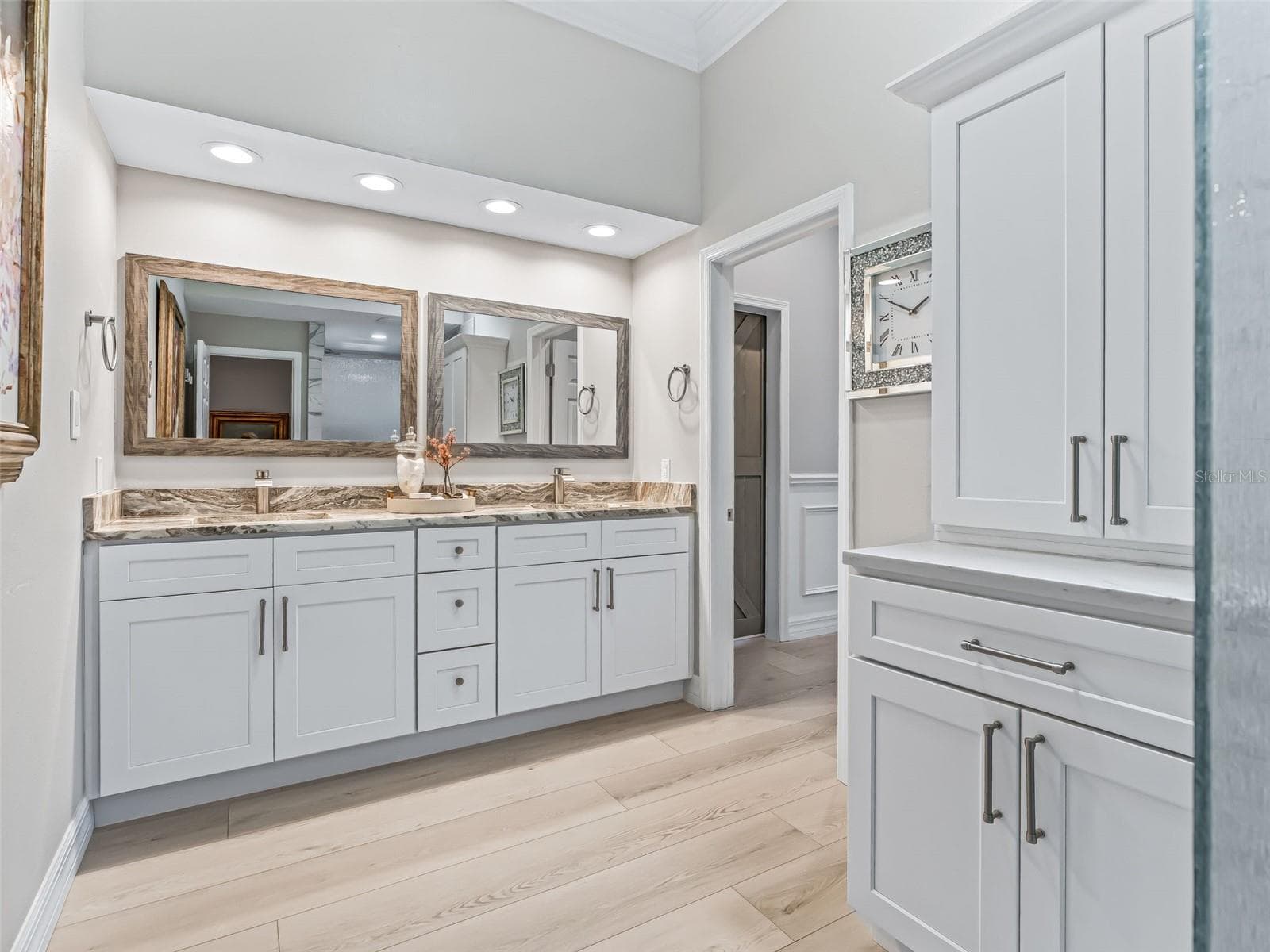 An expansive granite-topped vanity provides dual sinks, abundant cabinetry, a large wall mirror, and excellent lighting for everyday convenience. - 714 CIMARRON AVE, THE VILLAGES