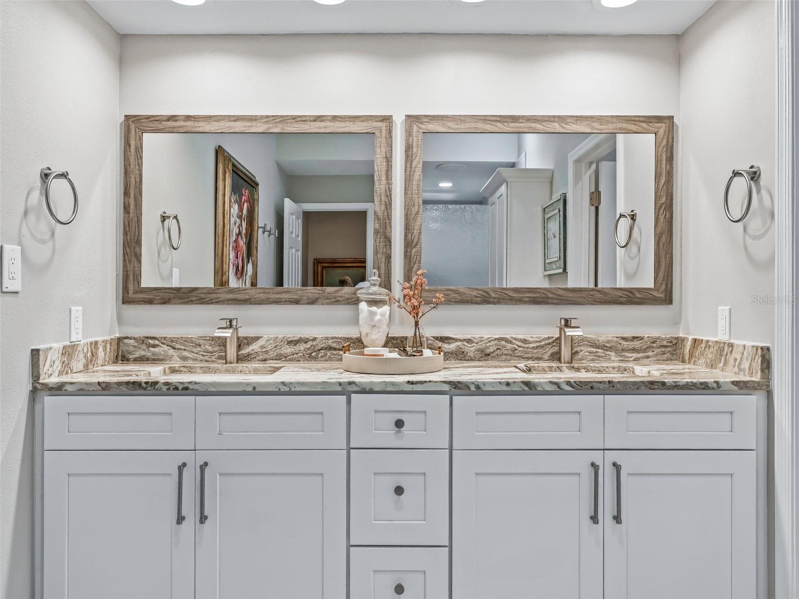 Closer view of the primary vanity showcases the granite countertop, dual sinks, generous storage, and polished finishes that complement the home's Premier styling. - 714 CIMARRON AVE, THE VILLAGES