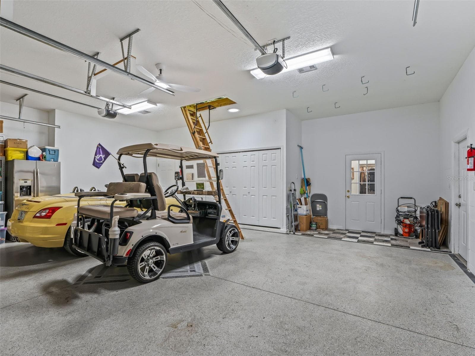 This spacious 27.4'x25.5' garage easily accommodates vehicles and golf carts while still providing room for storage and workspace. - 714 CIMARRON AVE, THE VILLAGES
