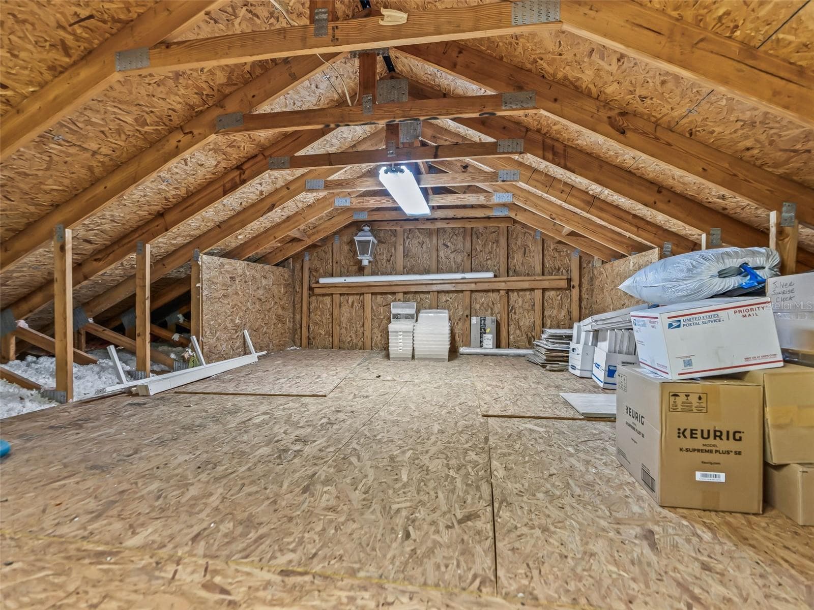 A large floored attic provides valuable additional storage space, easily accessed from the garage. - 714 CIMARRON AVE, THE VILLAGES