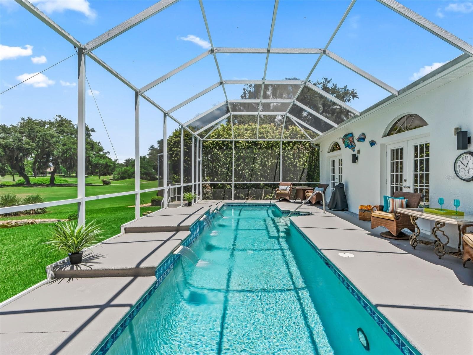 The impressive screened lanai showcases the 36' x 8' heated lap pool with plenty of surrounding deck space for lounging, entertaining, and enjoying the Florida lifestyle. - 714 CIMARRON AVE, THE VILLAGES