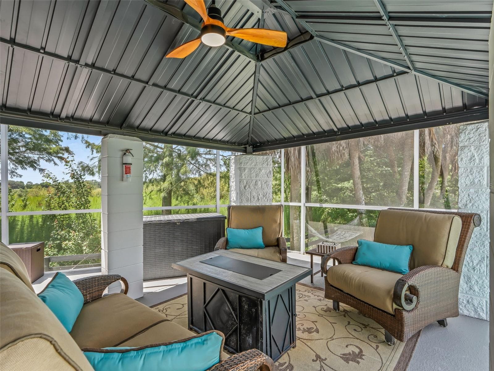 The new block gazebo with metal roof provides a shaded outdoor living area overlooking the pool and golf course—perfect for relaxing, dining, or entertaining. - 714 CIMARRON AVE, THE VILLAGES