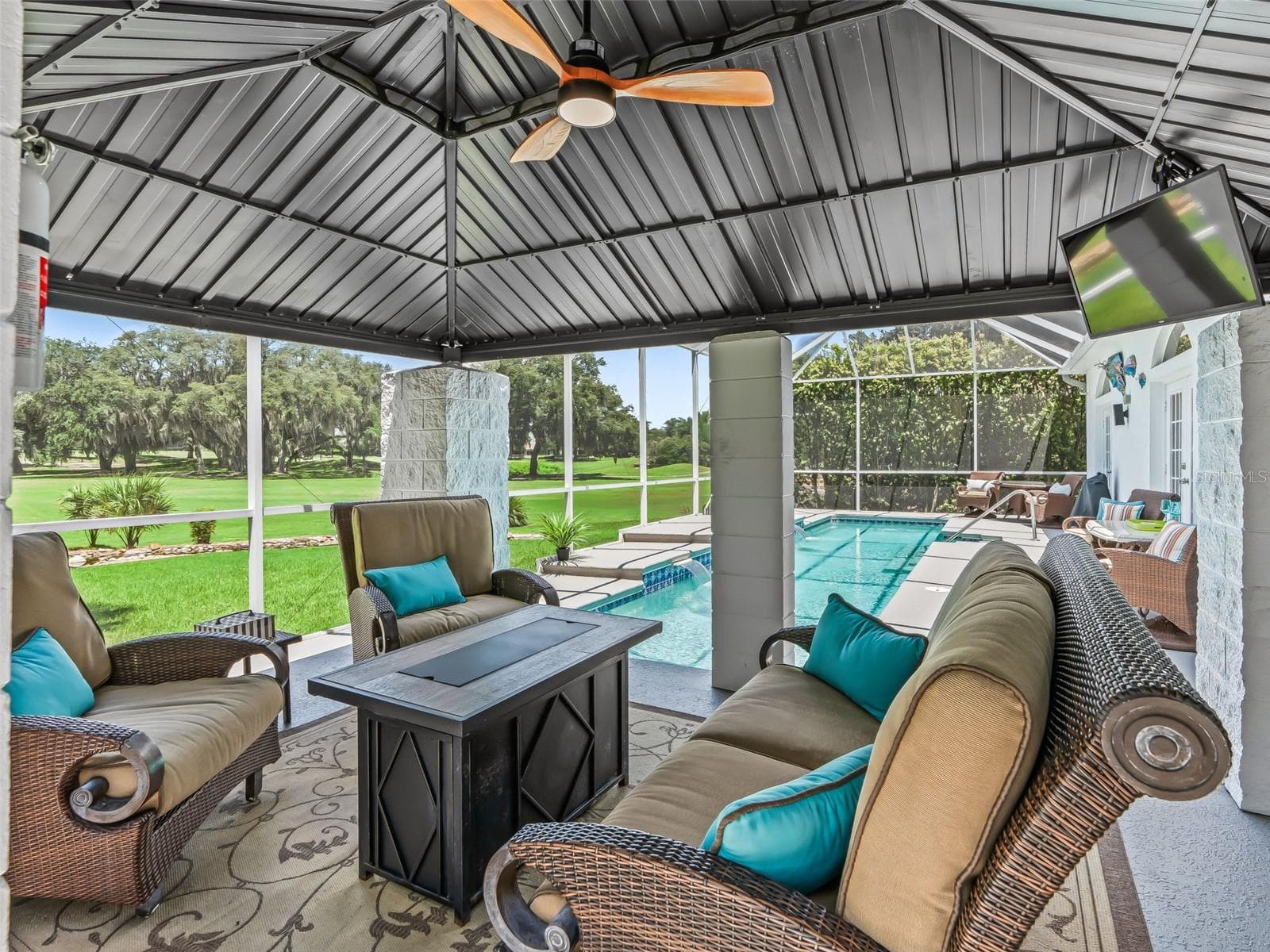 Relax under the shade of the metal-roofed gazebo while enjoying views across the pool and out toward the Tierra Del Sol Championship Golf Course. - 714 CIMARRON AVE, THE VILLAGES