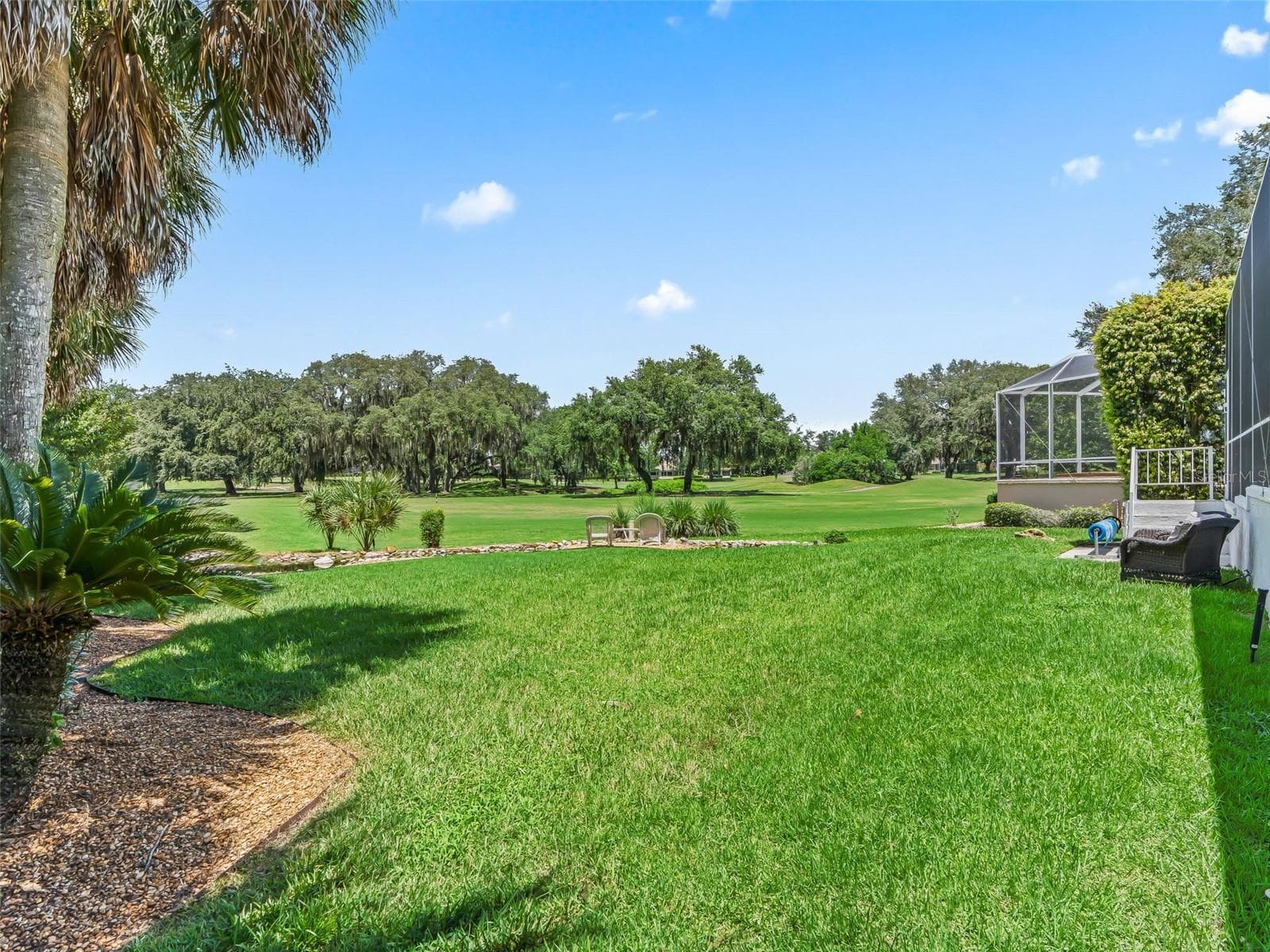 The oversized rear yard opens directly to the 10th fairway of Tierra Del Sol Championship Golf Course, creating a remarkable sense of space, privacy, and connection to the surrounding landscape - 714 CIMARRON AVE, THE VILLAGES