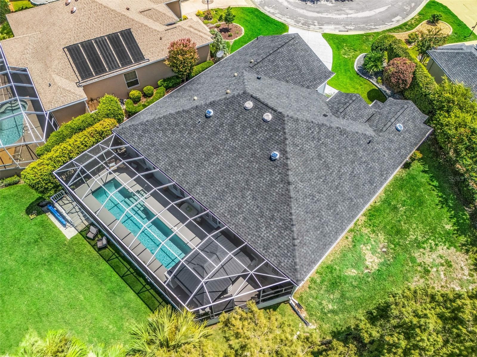 Overhead view highlights the substantial footprint of this custom Premier home, large screened pool enclosure, oversized homesite, and golf-front location. - 714 CIMARRON AVE, THE VILLAGES