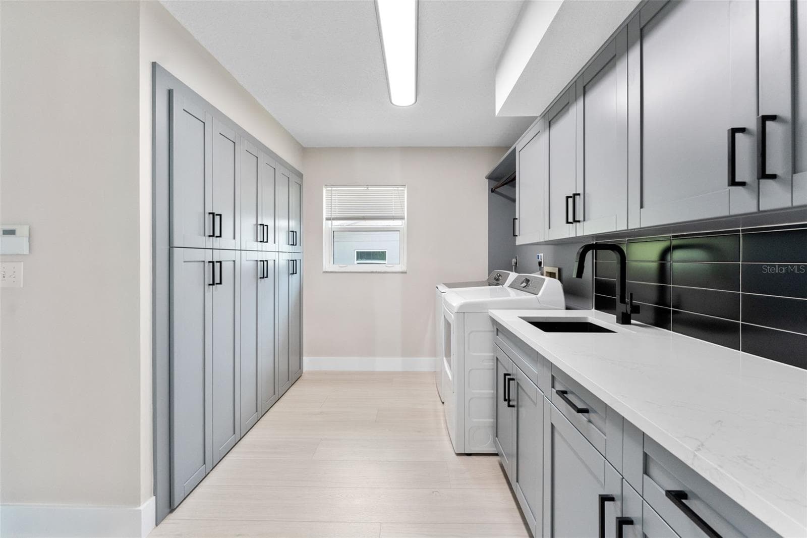 Laundry room with built-in cabinets for additional storage. - 2936 68TH AVE S, ST PETERSBURG